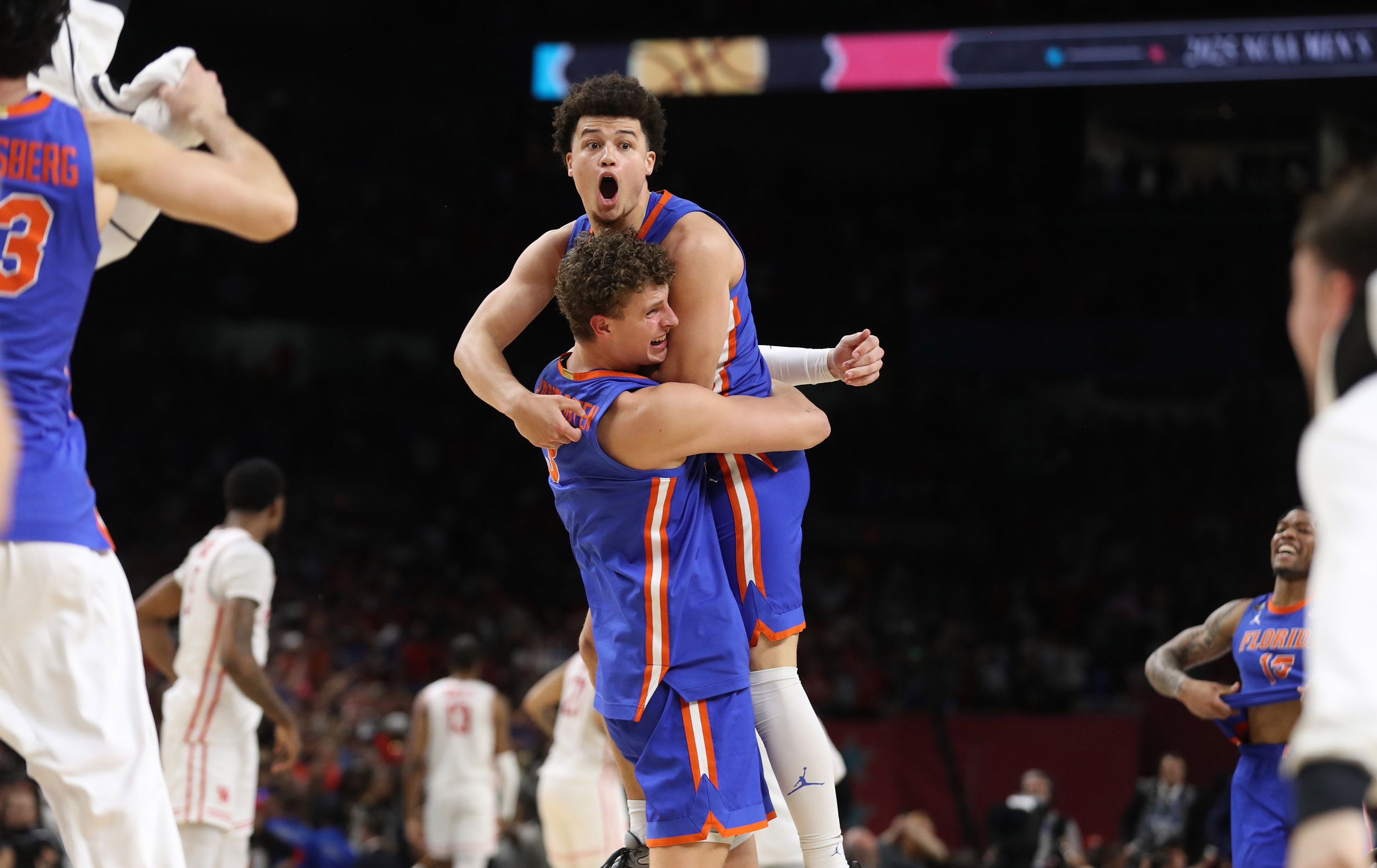Florida guard Walter Clayton Jr. jumps into the arms of...