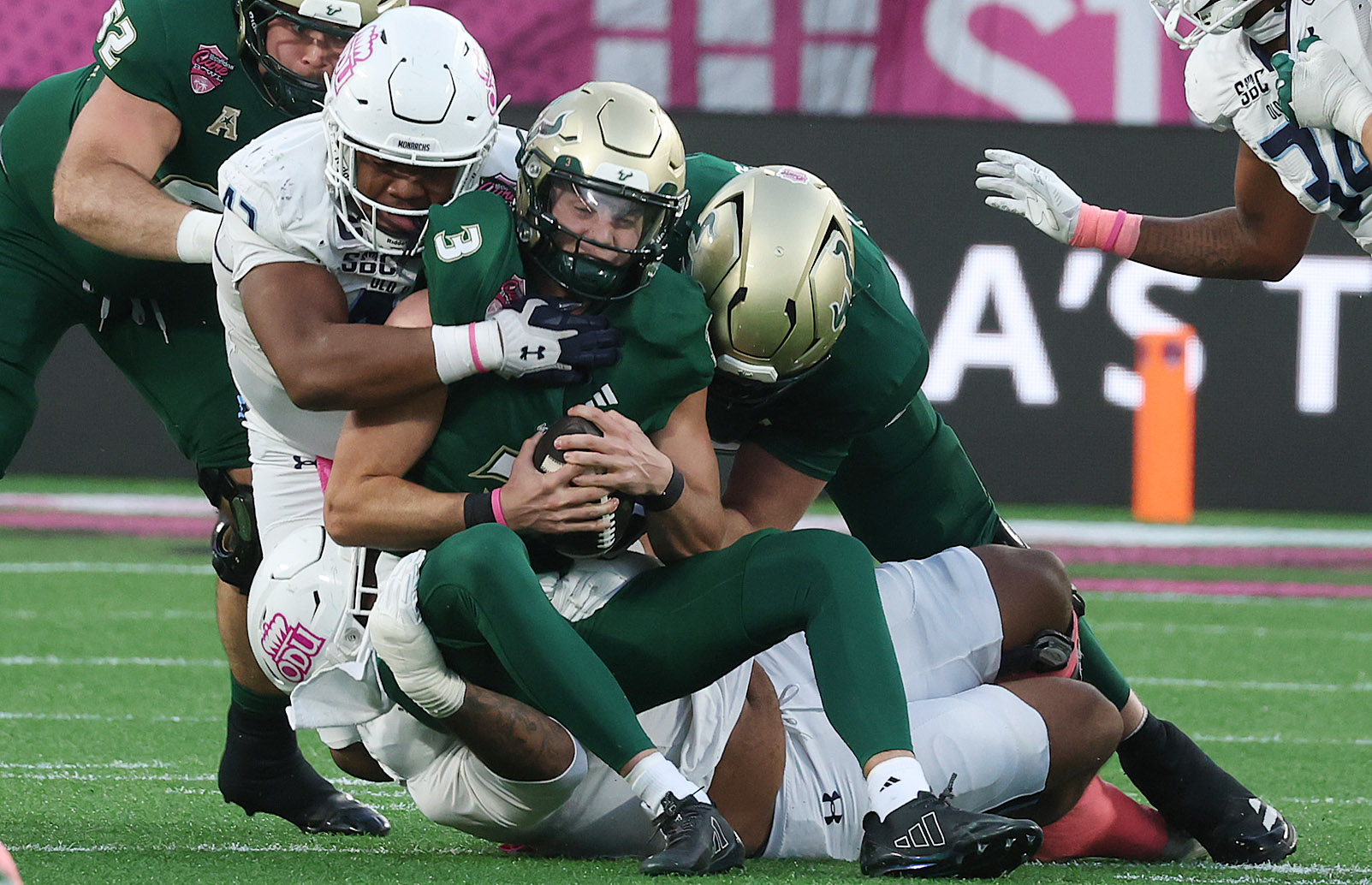 USF quarterback Gaston Moore (3) is sacked by multiple Old...