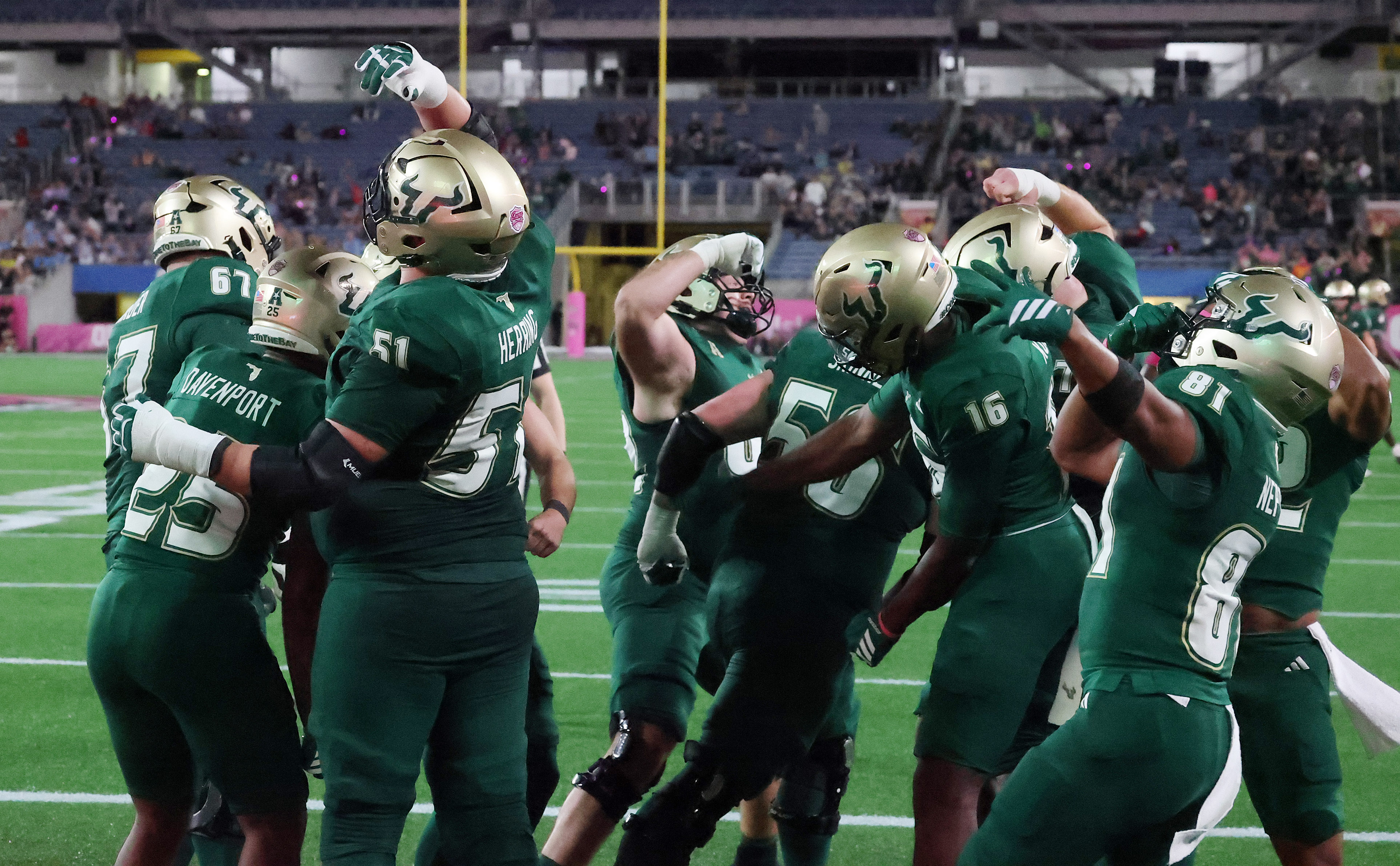 USF players celebrate after a touchdown during the Cure Bowl...