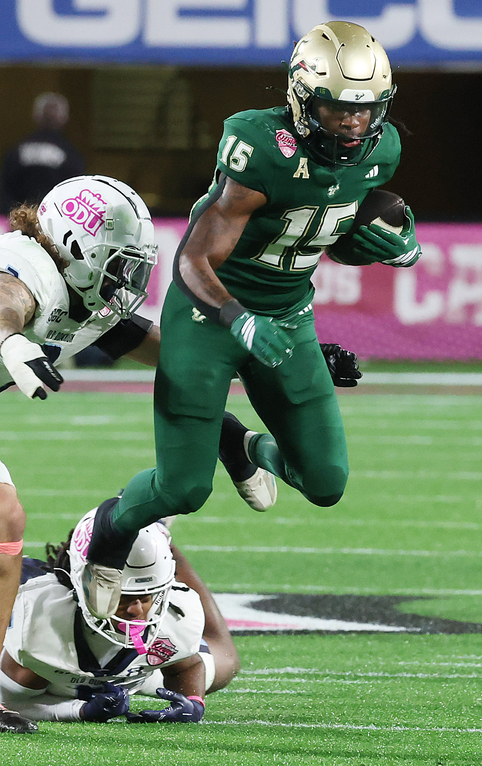 USF running back Alvon Isaac (15) leaps during the Cure...