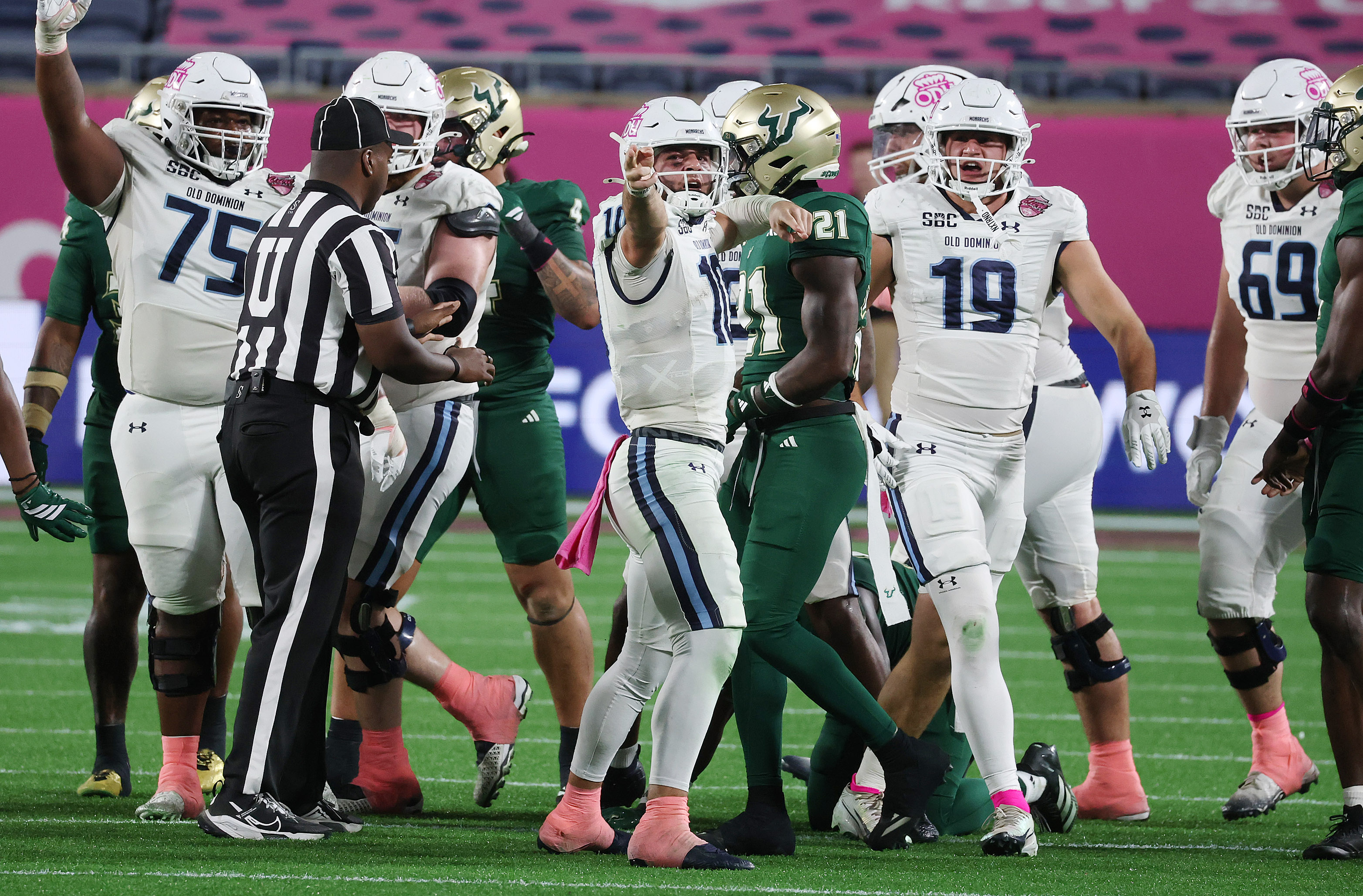Old Dominion quarterback Quinn Henicle (10) celebrates with teammates after...