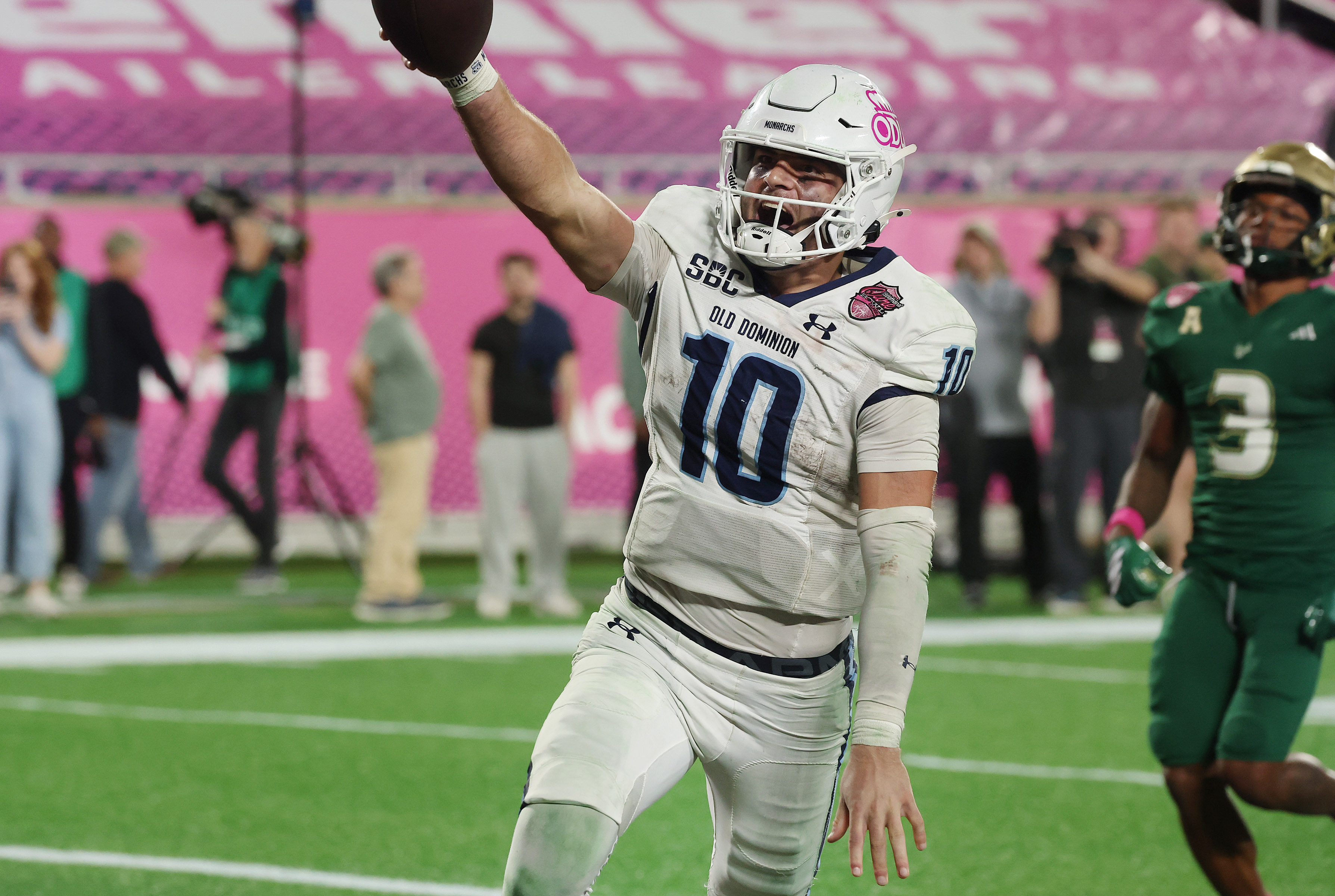 Old Dominion quarterback Quinn Henicle (10) screams in celebration as...