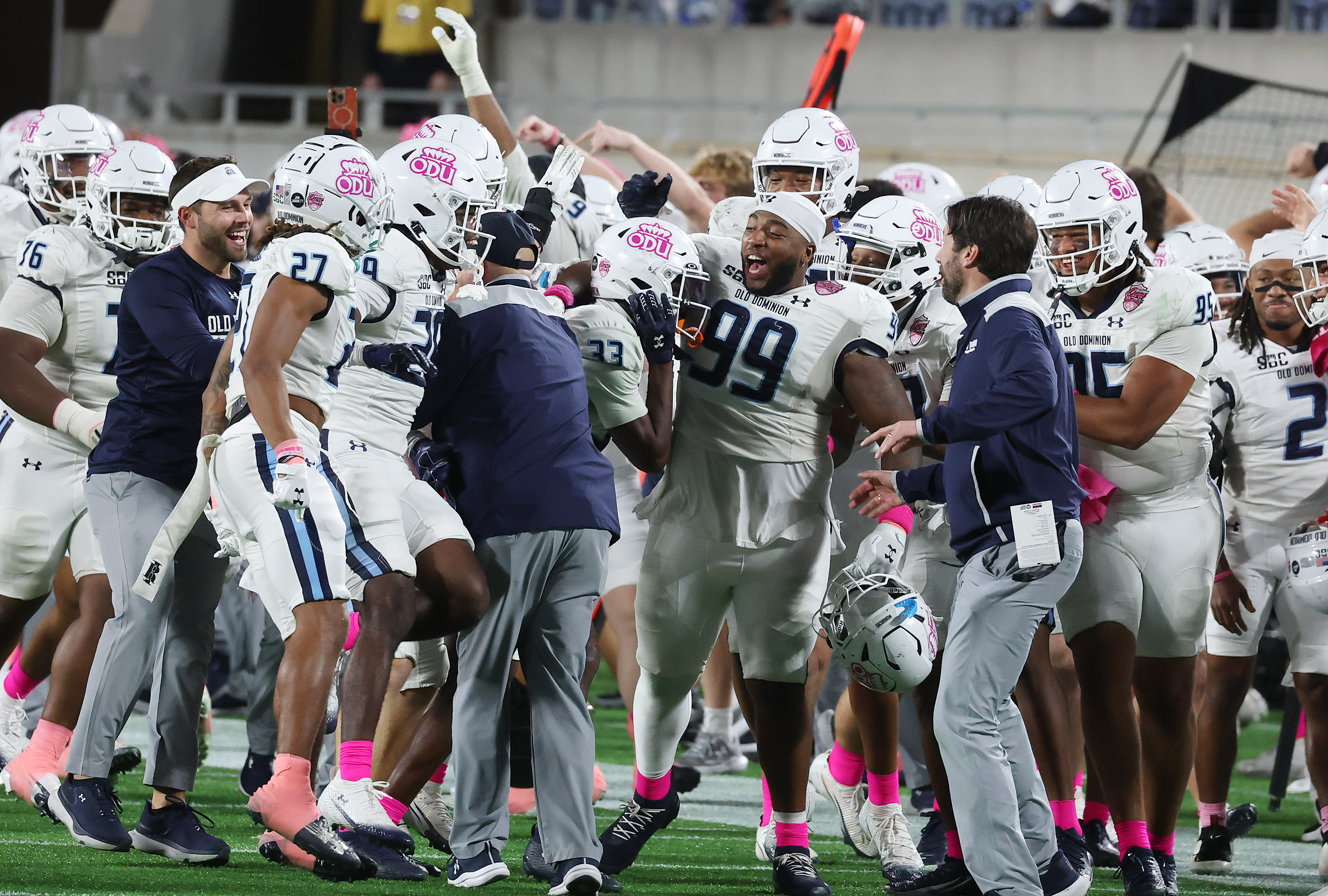 Old Dominion players celebrate on the sidelines after an interception...