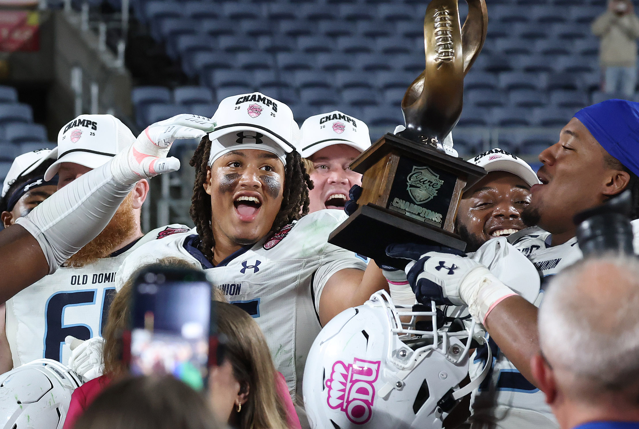 Old Dominion players celebrate after winning the Cure Bowl game...