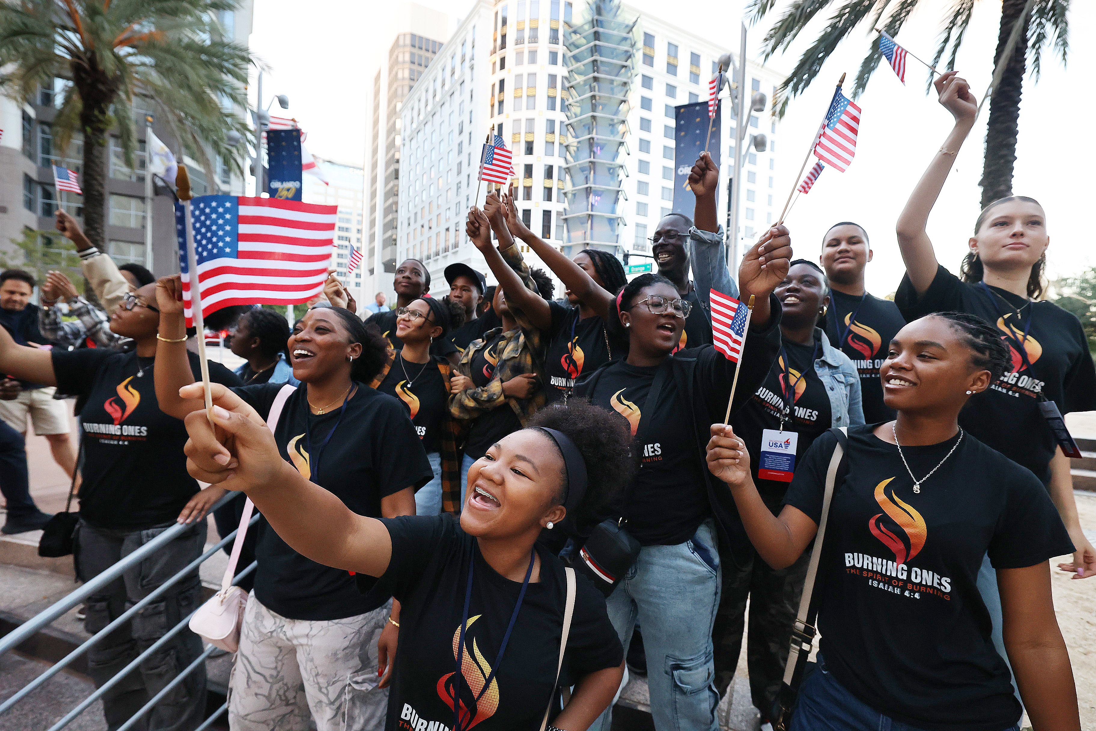Attendees cheer and wave flags during the Bring Hope to...