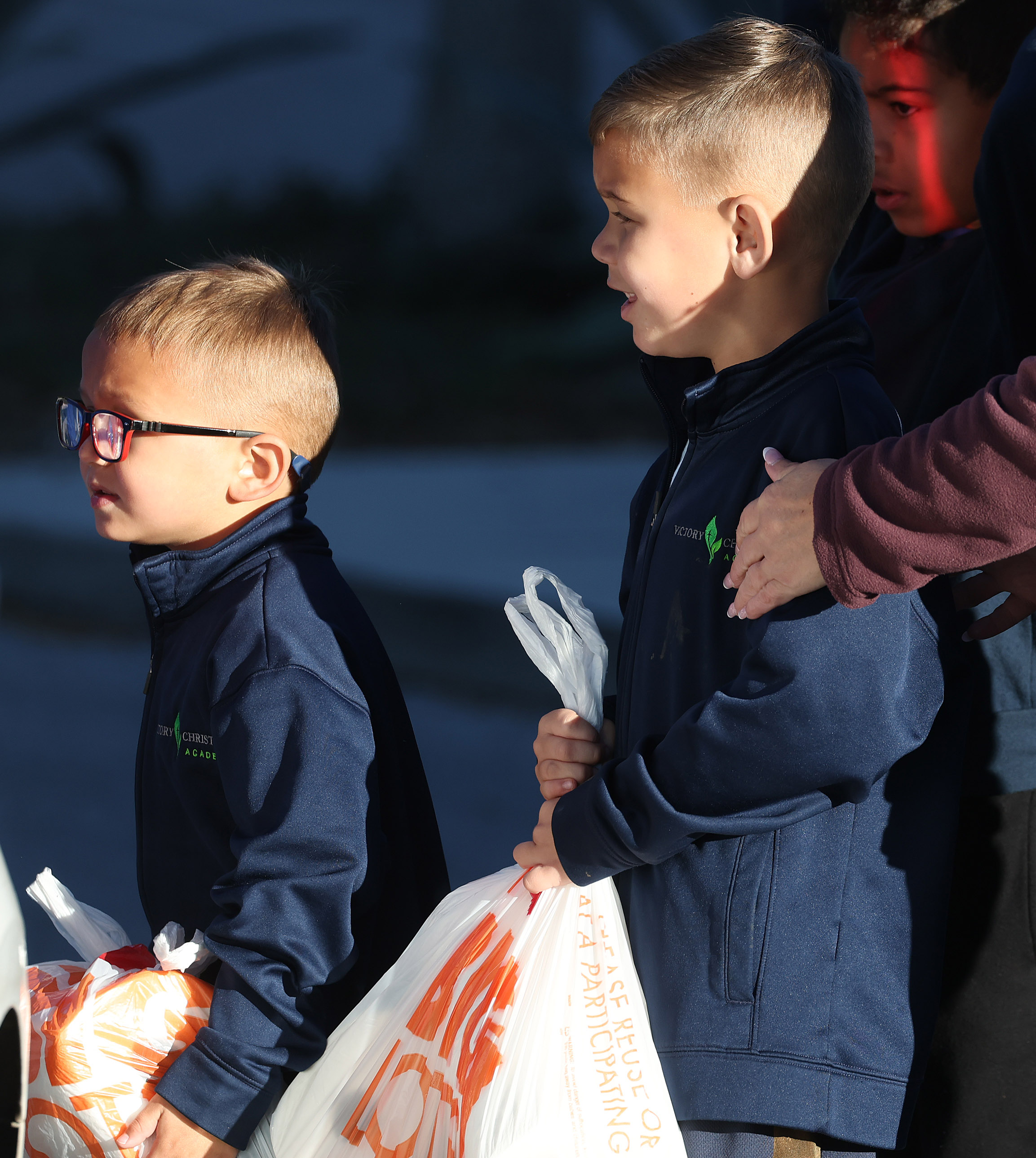 From left: Benjamin Jungwirth, Kenneth Jungwirth, and Elijah Robinson carry...
