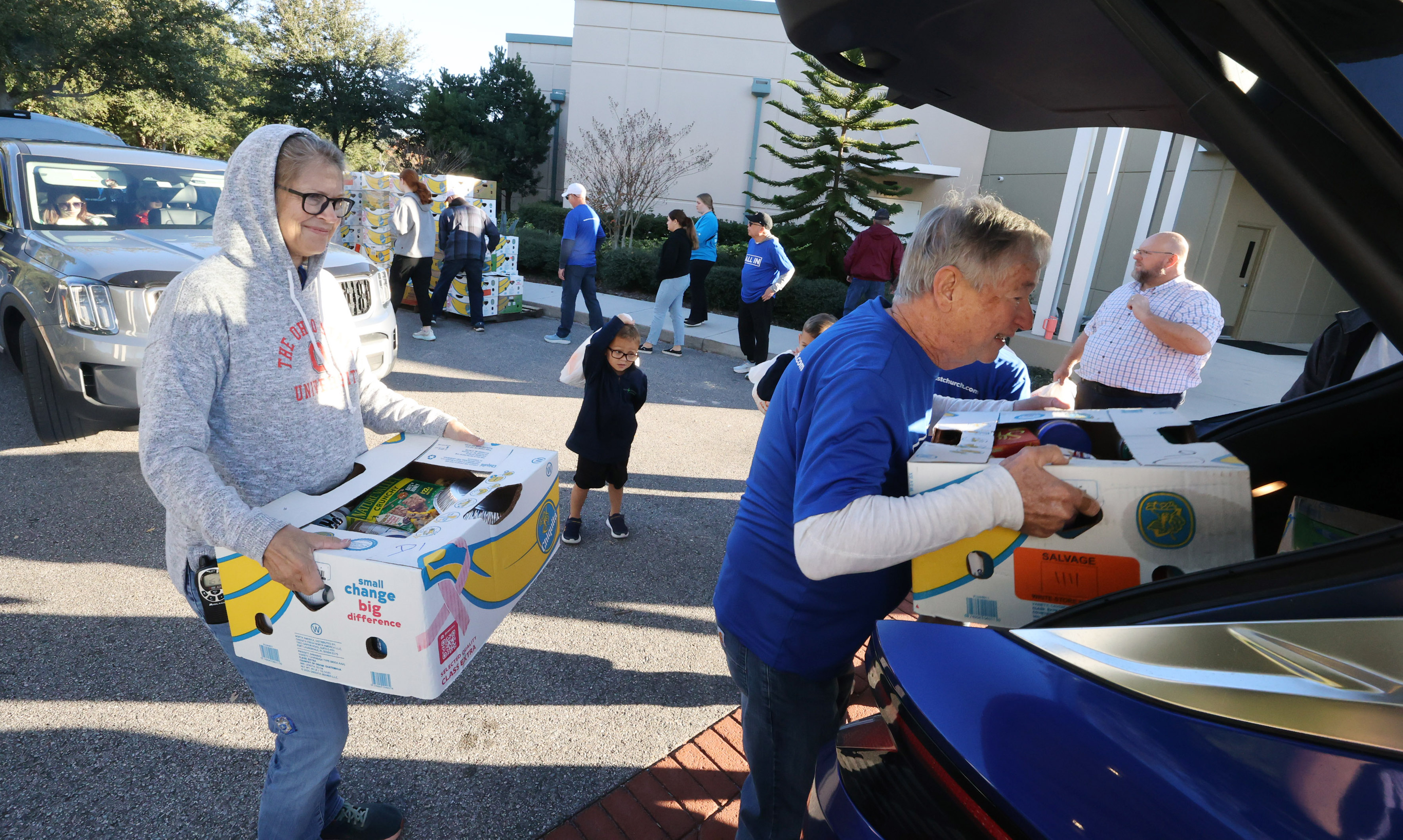 Boxes of food and home good items are loaded into...