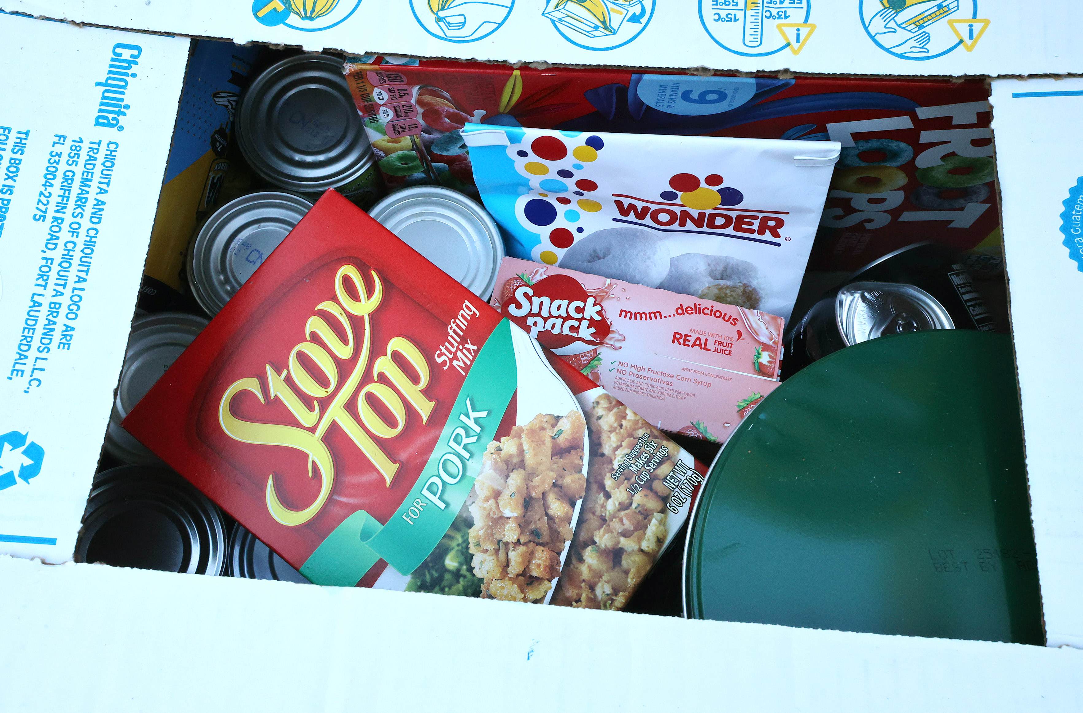 Boxes of food and home good items await distribution at...
