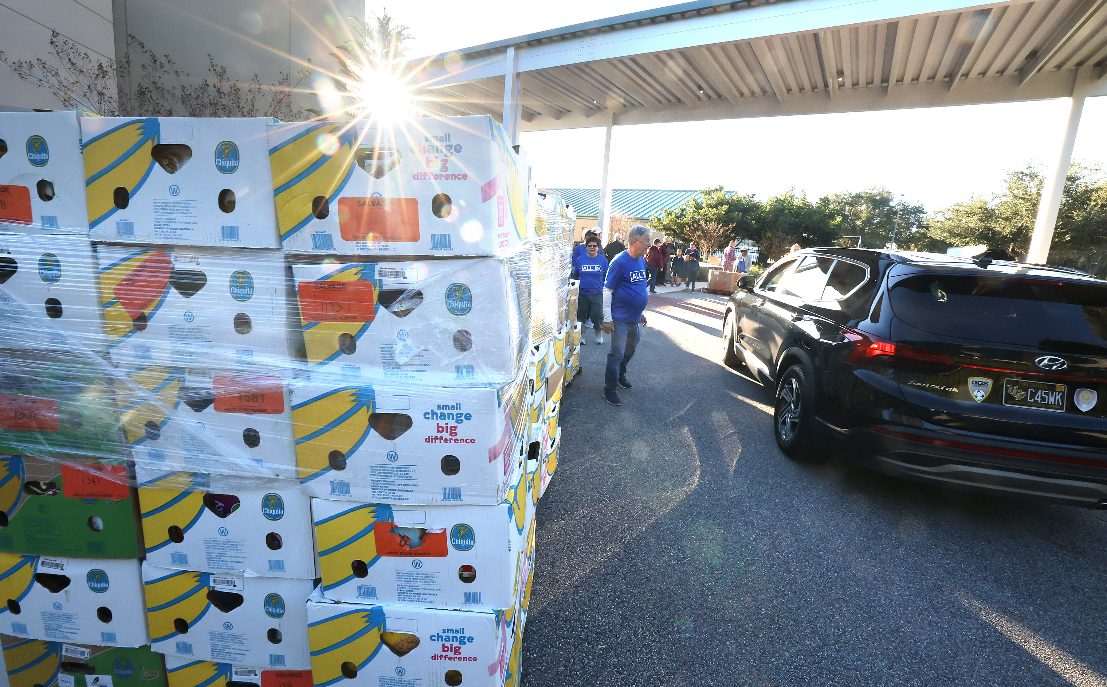 Boxes of food and home good items await distribution at...