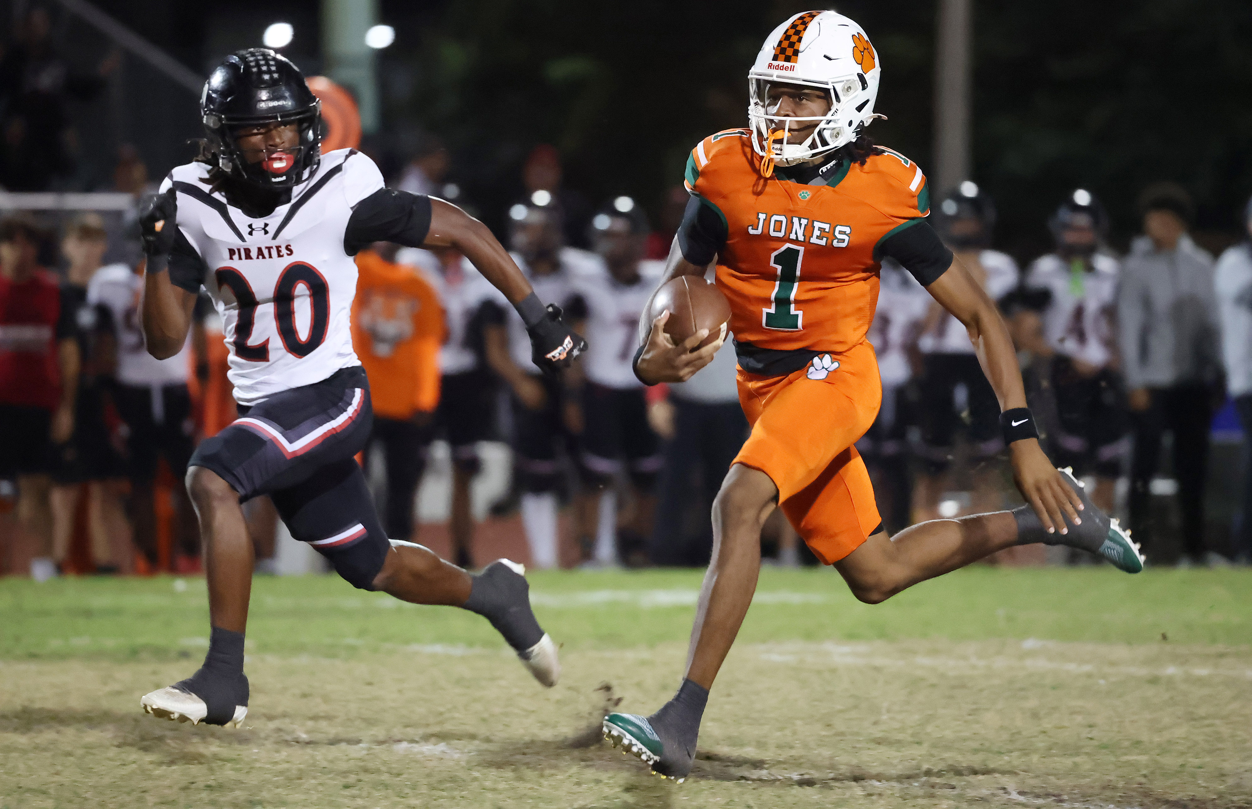 Jones quarterback Dereon Coleman (1) scrambles during the Port Charlotte...