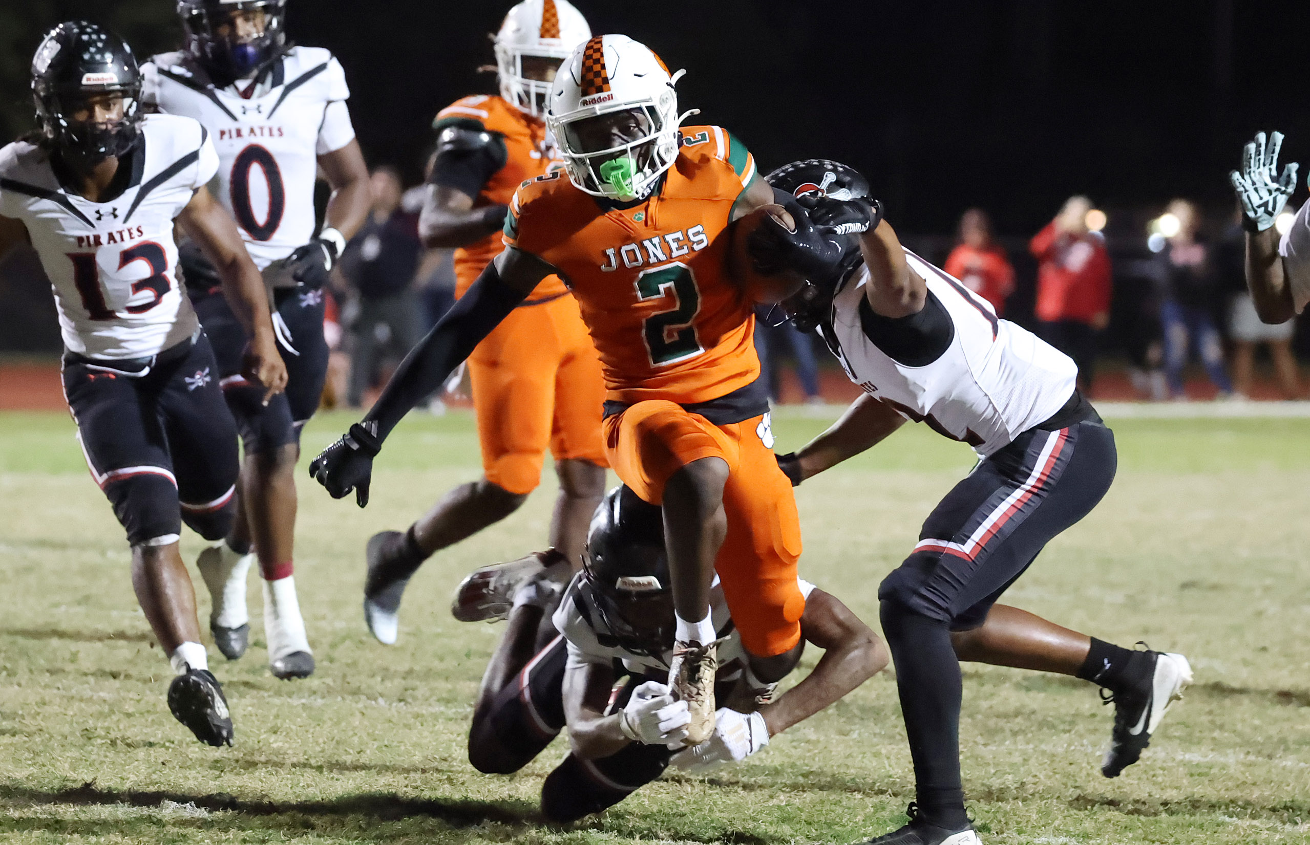 Jones receiver Larry Miles (2) leaps over defenders during the...
