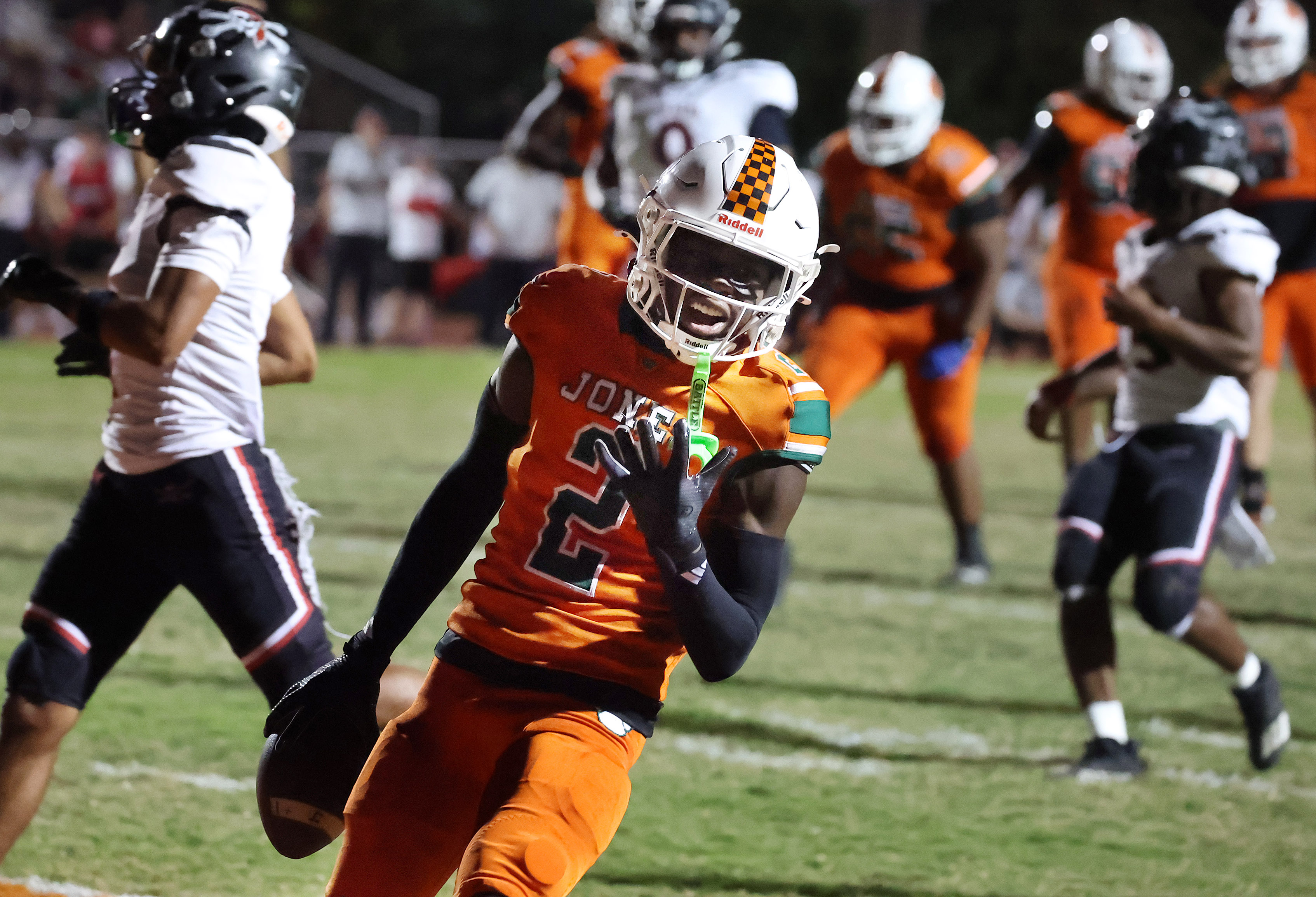 Jones receiver Larry Miles (2) celebrates as he runs a...