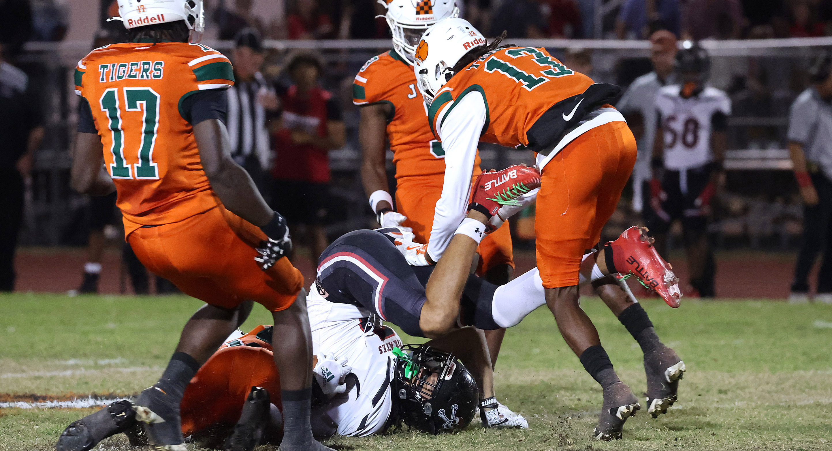 Port Charlotte wide receiver Dallas Lambert (bottom) is knocked down...