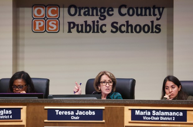 Orange County school board chair Teresa Jacobs comments, with board members Anne Douglas, left, and Maria Salamanca, right, listening during a 6-hour board meeting, Tuesday, Dec. 16, 2025. Superintendent Maria Vazquez recommended the closure of seven under-enrolled schools, including Union Park Middle School and Bonneville, Chickasaw, Eccleston, Meadow Woods, McCoy and Orlo Vista elementary. (Joe Burbank/Orlando Sentinel)