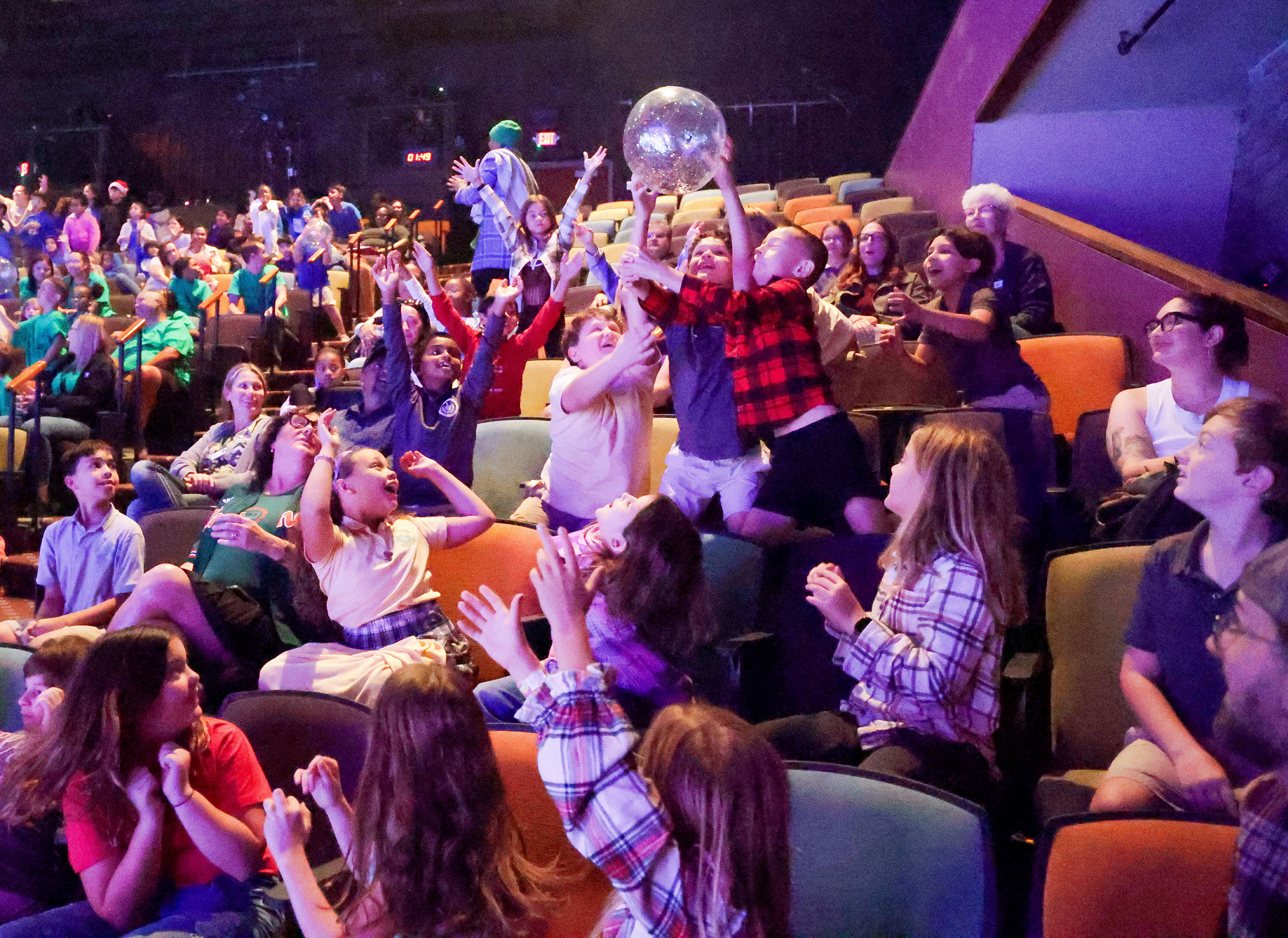 Students react as âsnowballsâ bounce into the audience during a...