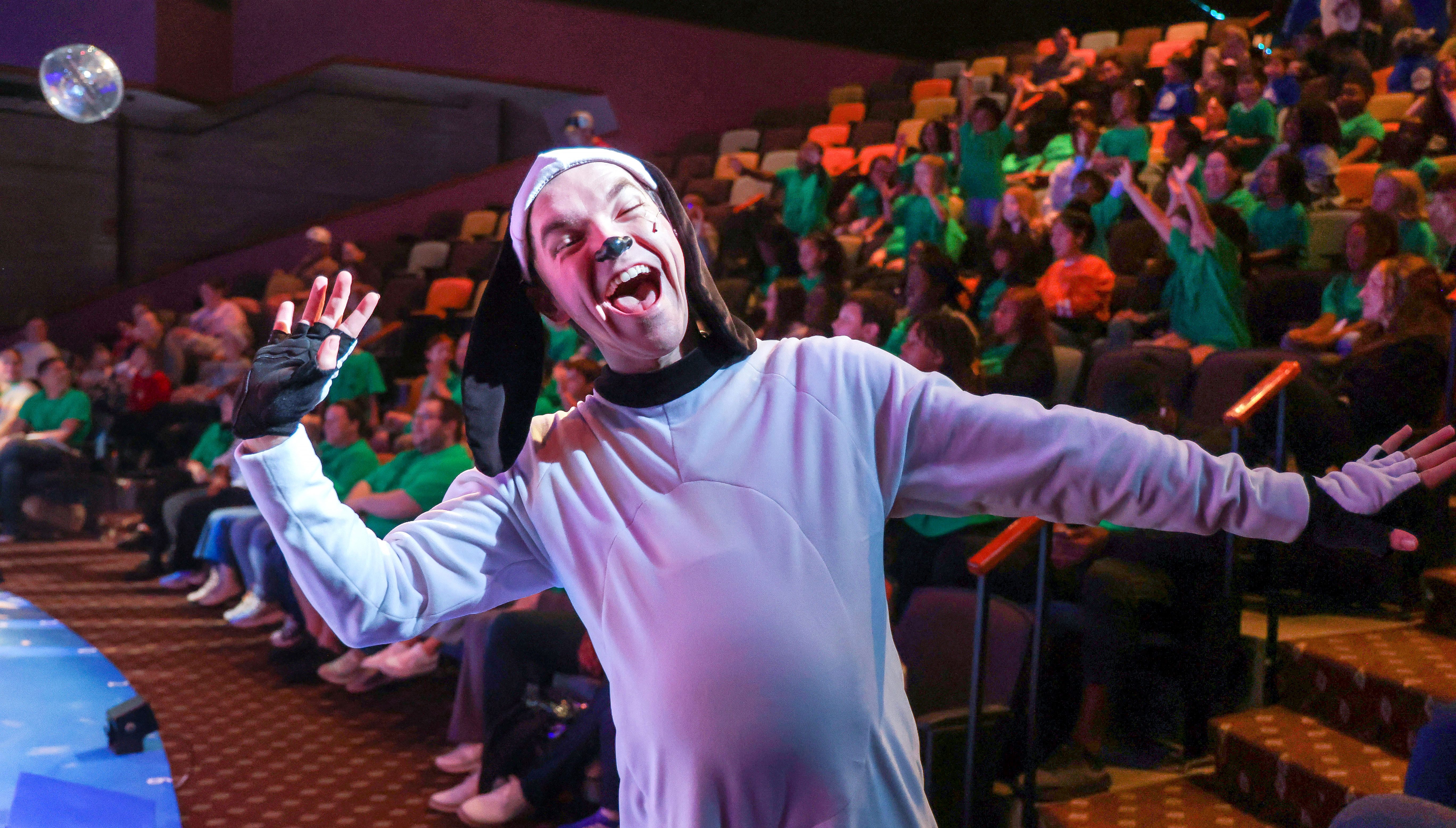 Snoopy runs into the audience as the cast of 