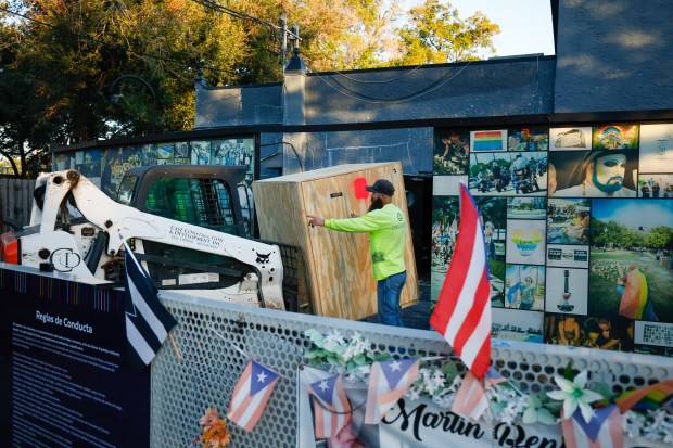 A crew begins the process of removing items from the Pulse Nightclub site on Monday, December 22, 2025, as the effort to demolish the sitewhere the mass shooting occurred in June 2016begins, making way for a permanent memorial. Items being removed and stored include chandeliers, large posters, a cash register and other interior decorative items. (Rich Pope/ Orlando Sentinel)