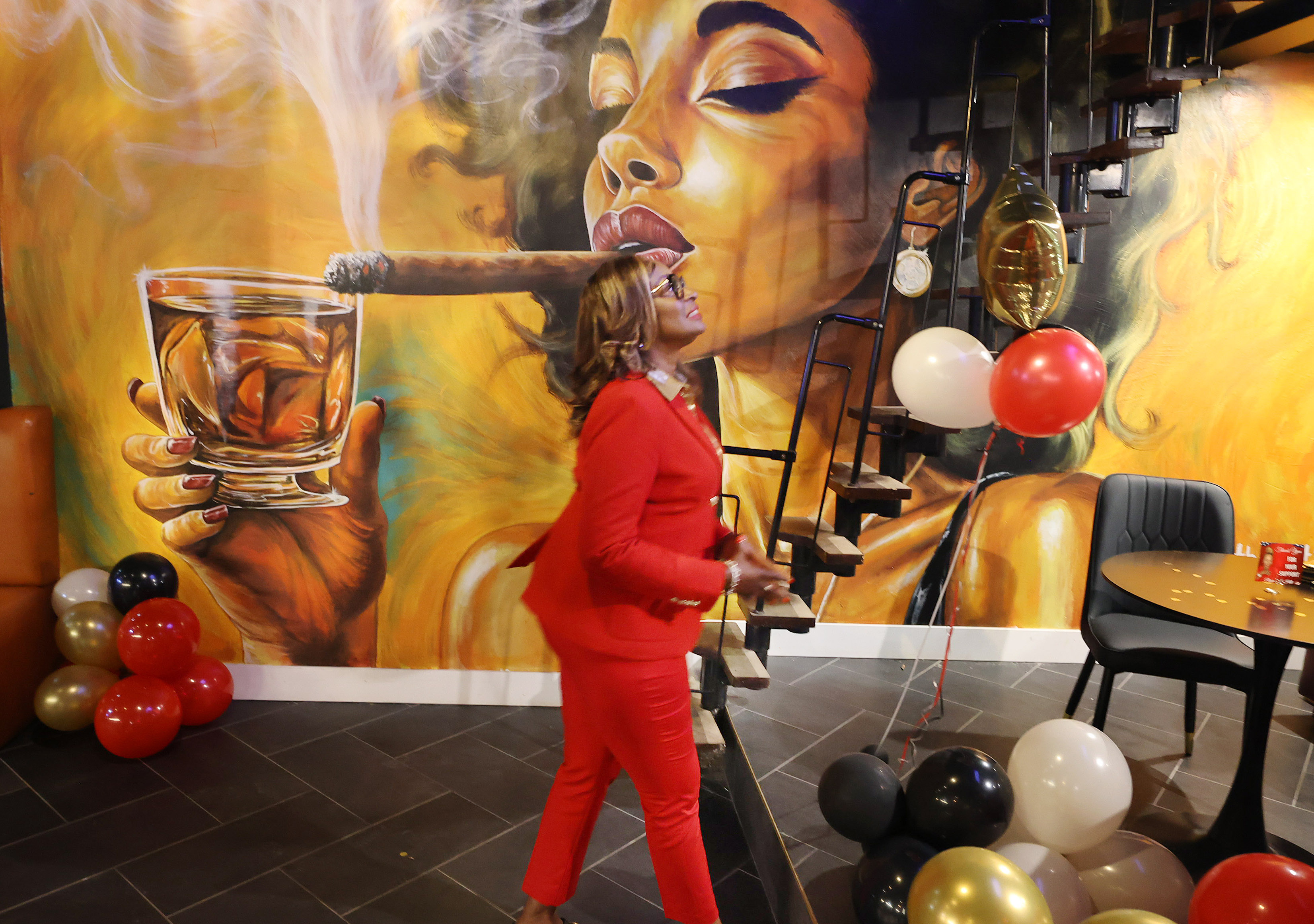 Regina Hill looks up at a video screen showing election...