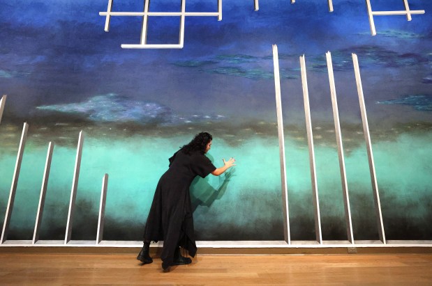 The 2025 Florida Prize in Contemporary Art winner Nathalie Alfonzo talks about her mural "LineScapeOnset" during a preview of the exhibition at the Orlando Museum of Art on May 30, 2025. Alfonzo, from Coral Springs, was awarded $20,000 for her winning artwork that measures 87 feet wide by 17 feet tall. The mural took three weeks to paint. (Joe Burbank/Orlando Sentinel)