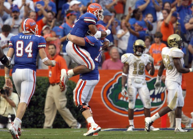 Florida quarterback Chris Leak jumps into the arms of offensive lineman Phil Trautwein (75) following a touchdown during the Gators' 42-0 win against UCF Sept. 9, 2006 at Ben Hill Griffin Stadium in Gainesville. (Orlando Sentinel/Gary W. Green)
