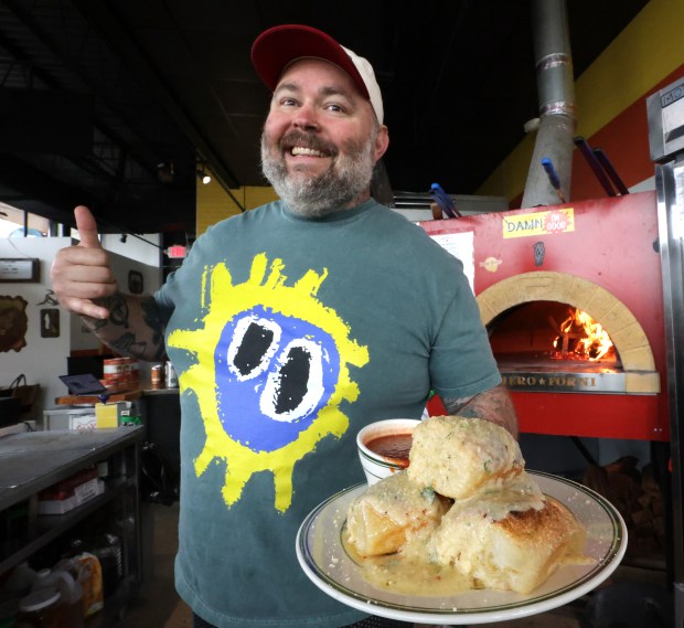 Pizza Bruno owner Bruno Zacchini, pictured here with an order of his giant garlic knots at his Maitland Social location. "2025 was probably a very hard year for most, including myself." (Joe Burbank/Orlando Sentinel)