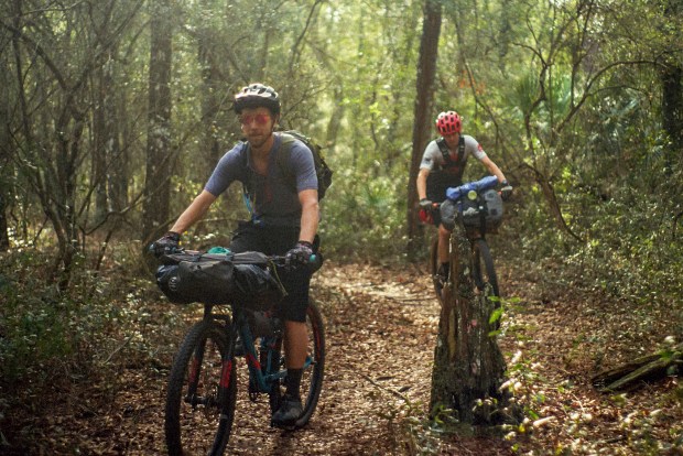 Patrick Connolly and Kevin Bolton ride on singletrack mountain bike trails in Withlacoochee State Forest during the second day of a bike ride across Florida on Feb. 16, 2025. (Courtesy of Ben Chalone)