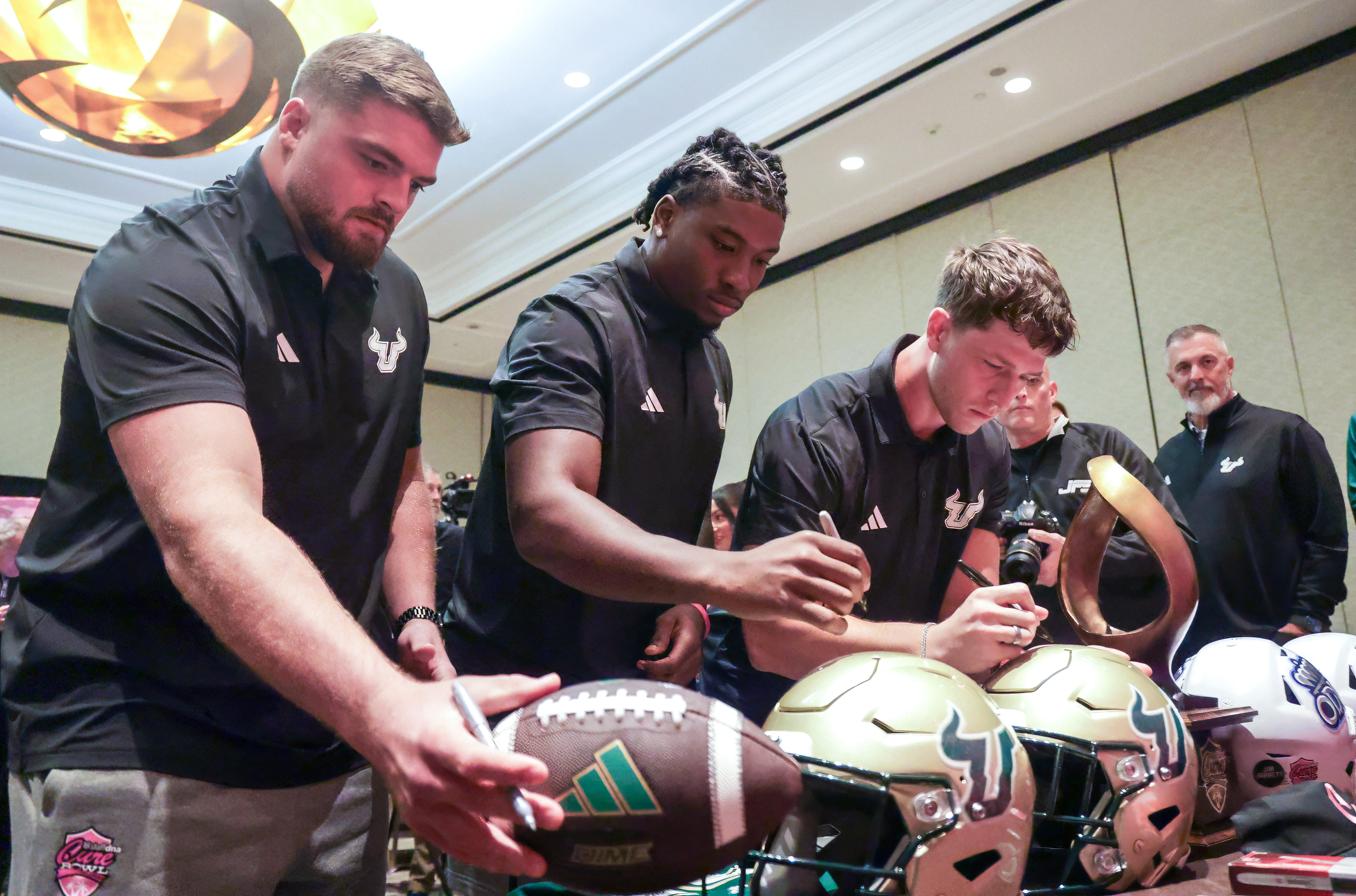 University of South Florida join players, from left, Cole Best,...