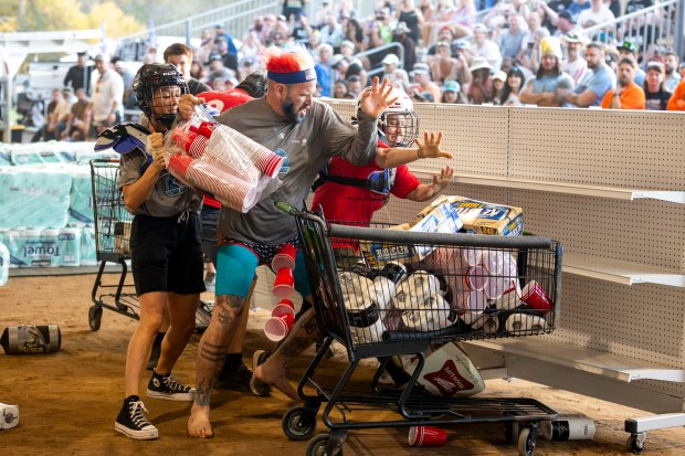 Contestants get physical and hands on during the "Hurricane Party Prep: Grocery Aisle Brawl" during the second Florida Man Games, held at the St. Johns County Fairgrounds on March 1, 2025. (Patrick Connolly/Orlando Sentinel)