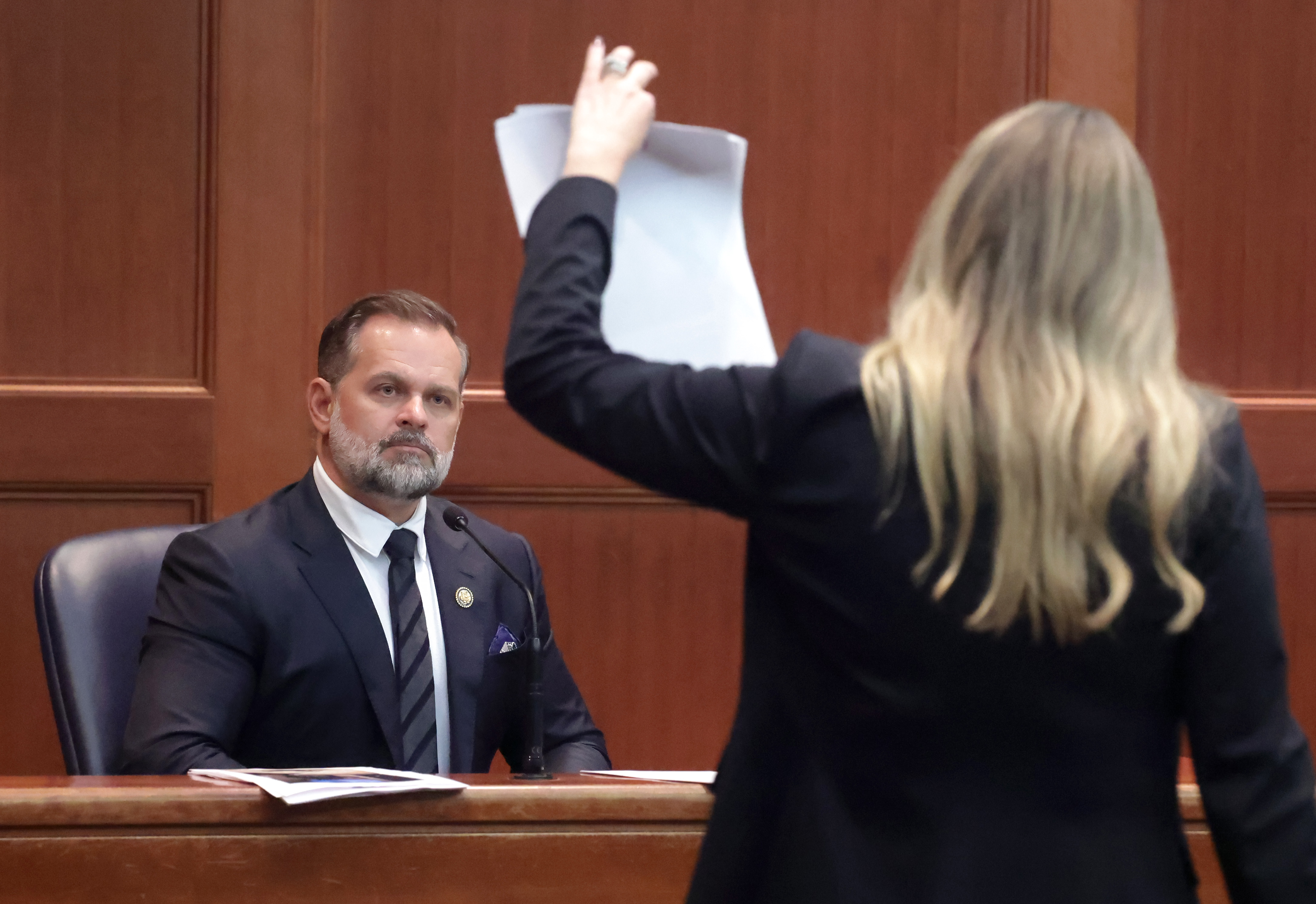 U.S. Rep. Cory Mills looks at evidence photos during cross...