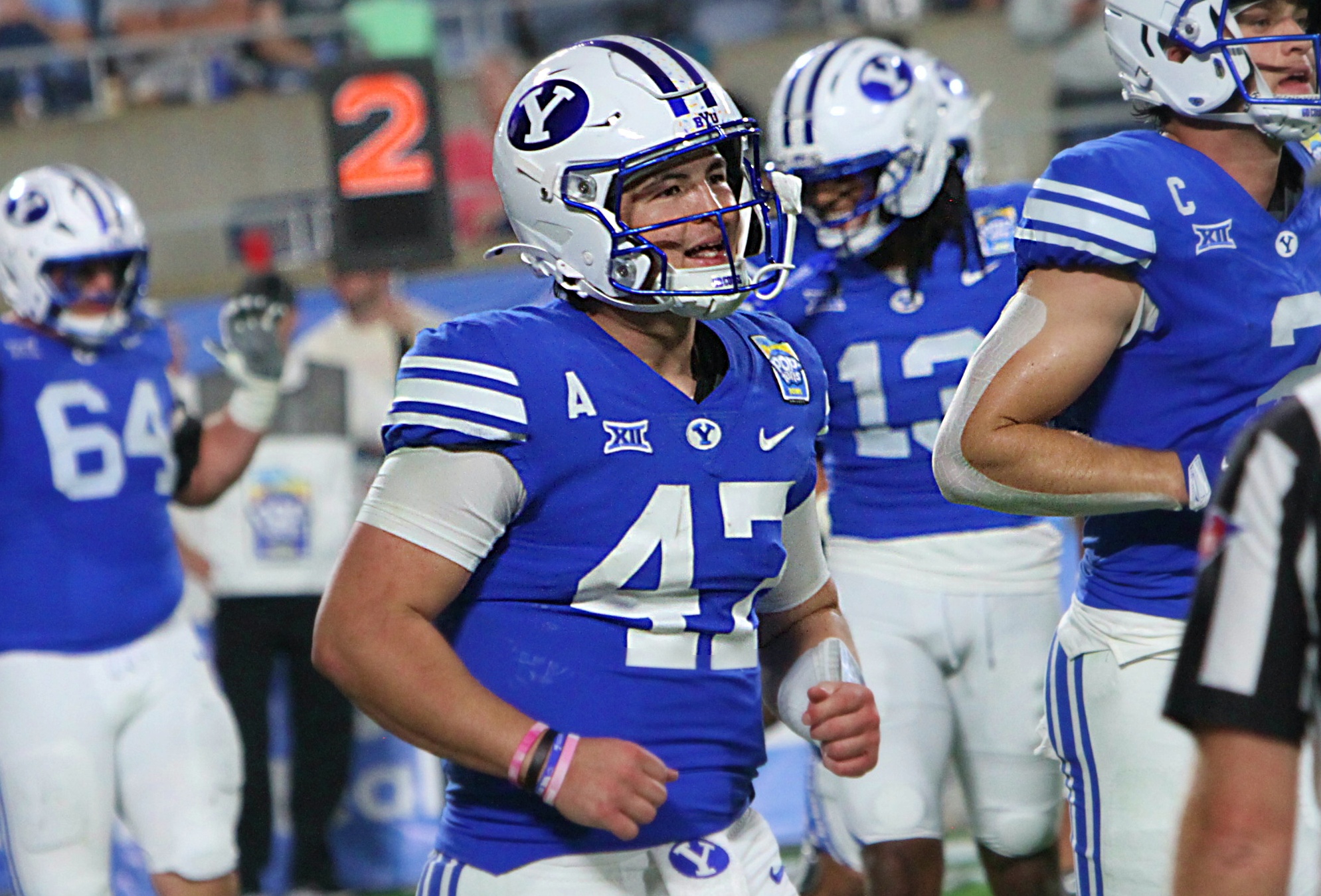 BYU quarterback Bear Bachmeier runs off the field after the...