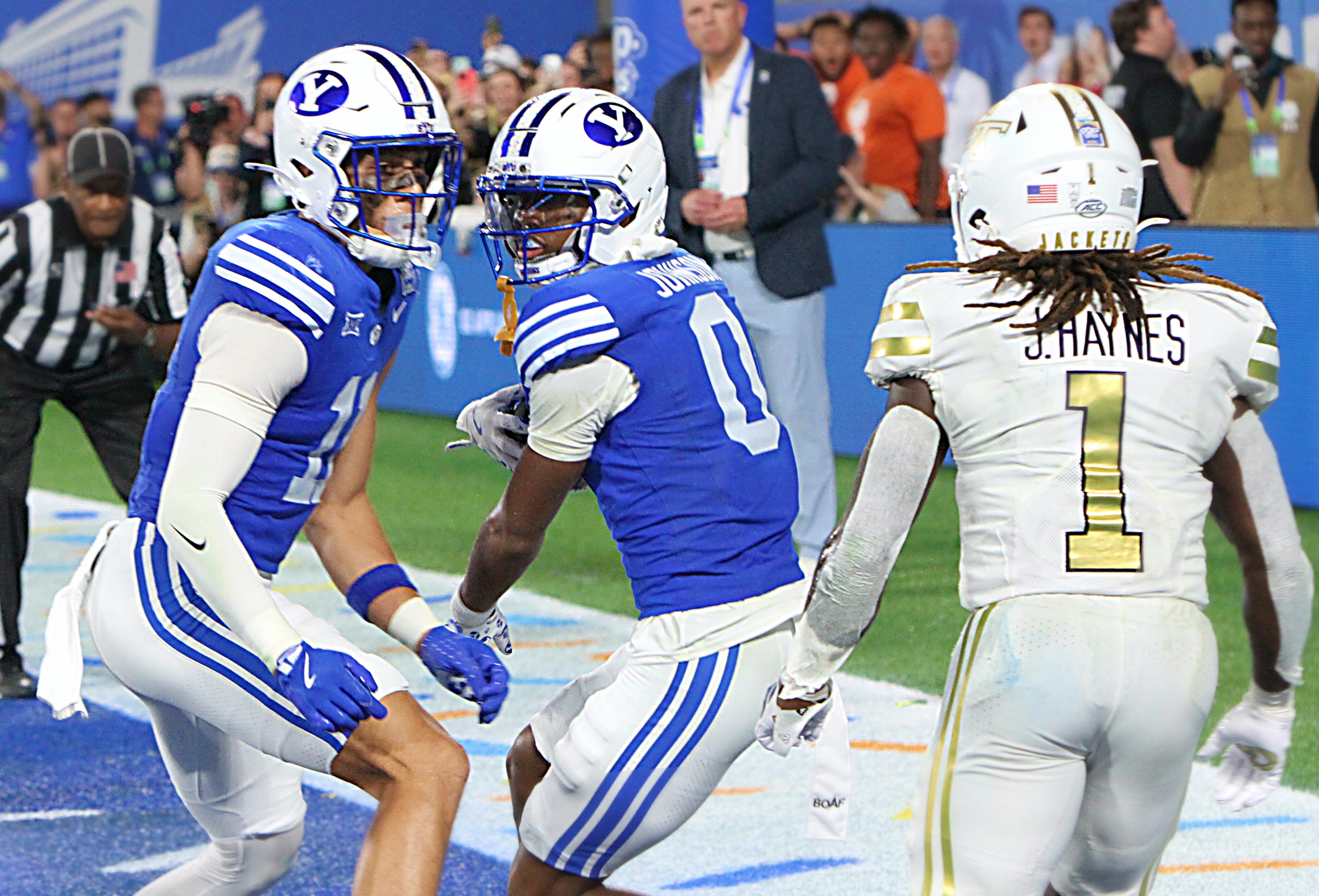 BYU defensive back Evan Johnson (0) and teammate Tayvion Beasley...