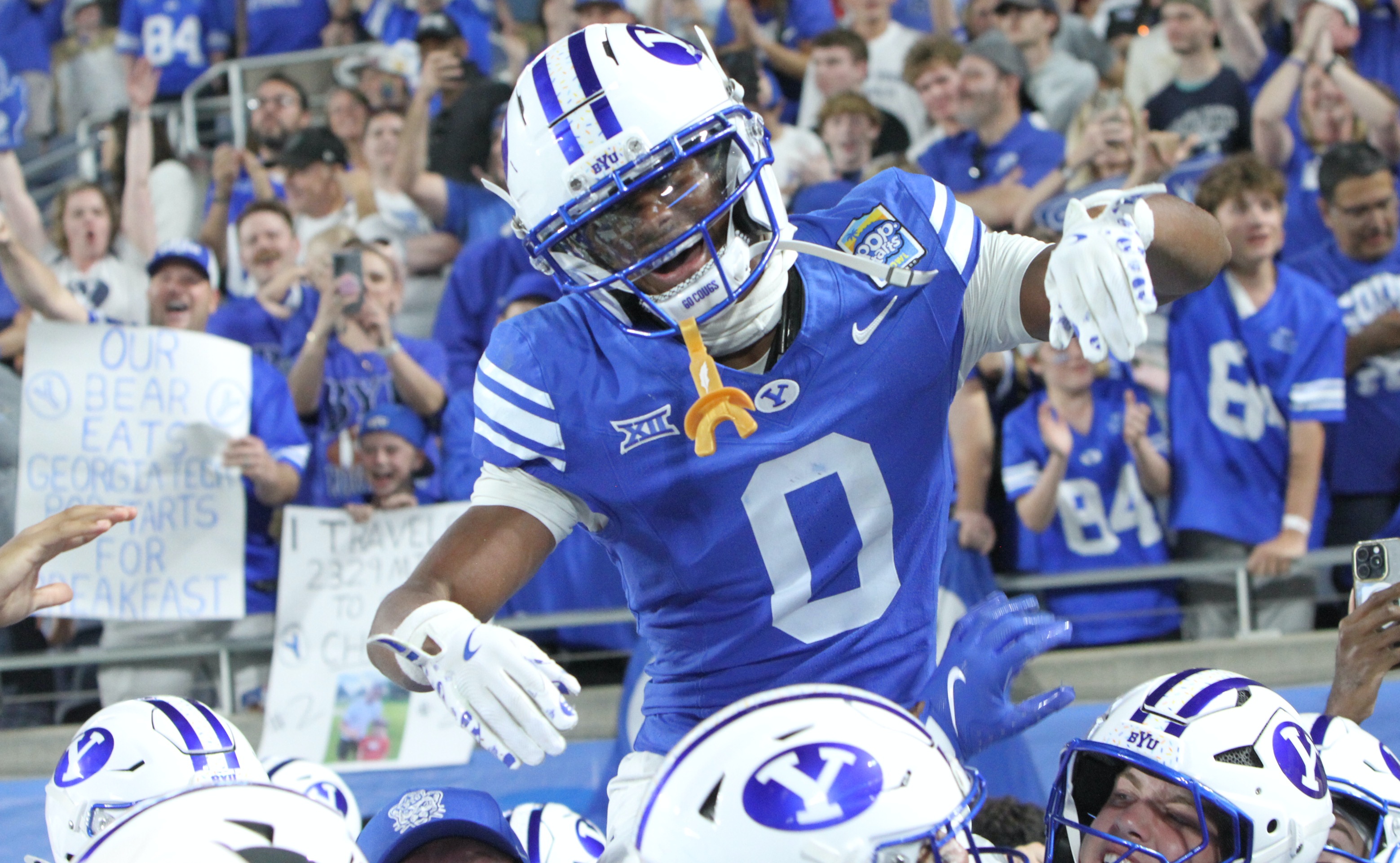 BYU defensive back Evan Johnson is carried off the field...