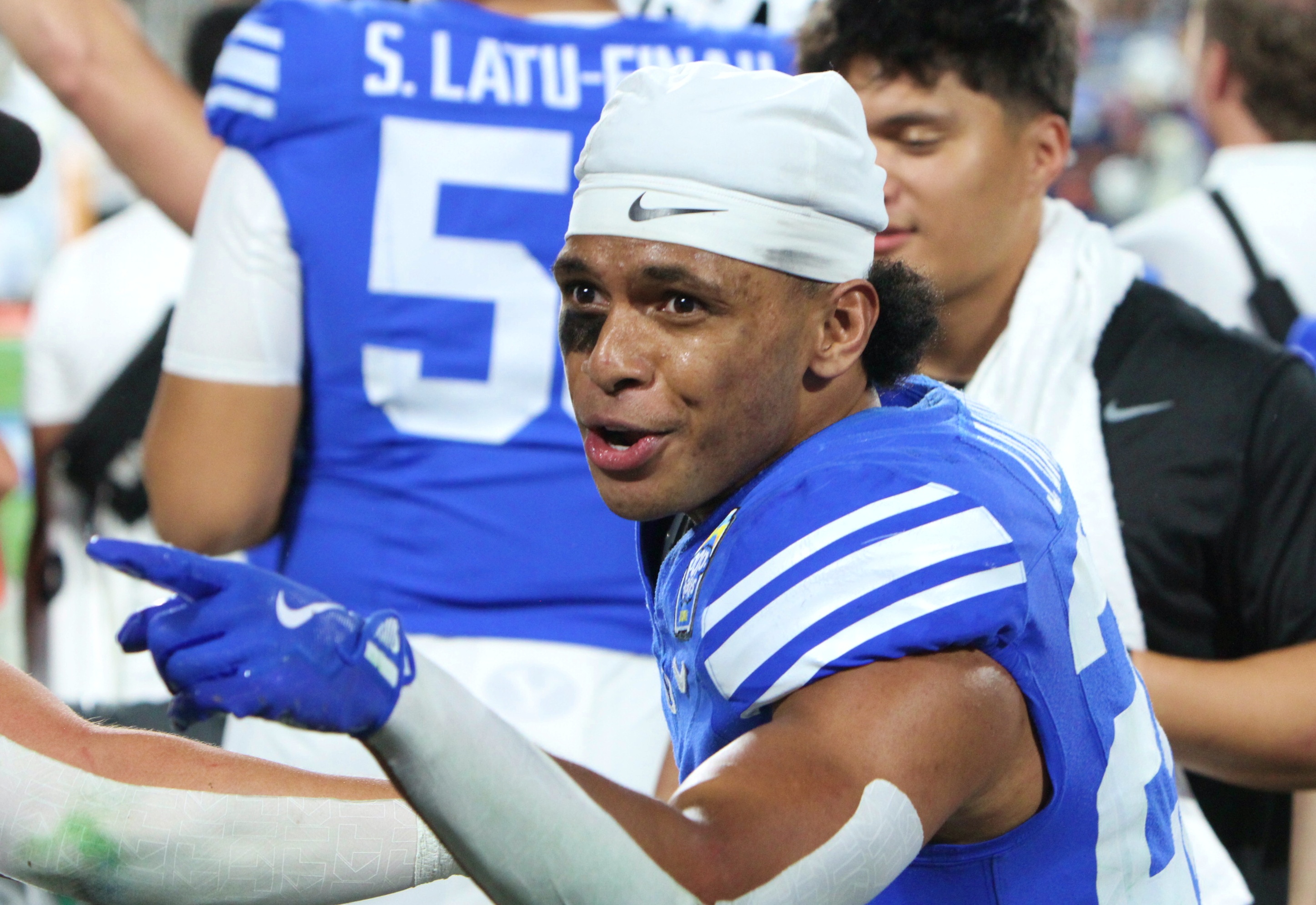 BYU running back Jovesa Damuni is excited on the sideline...