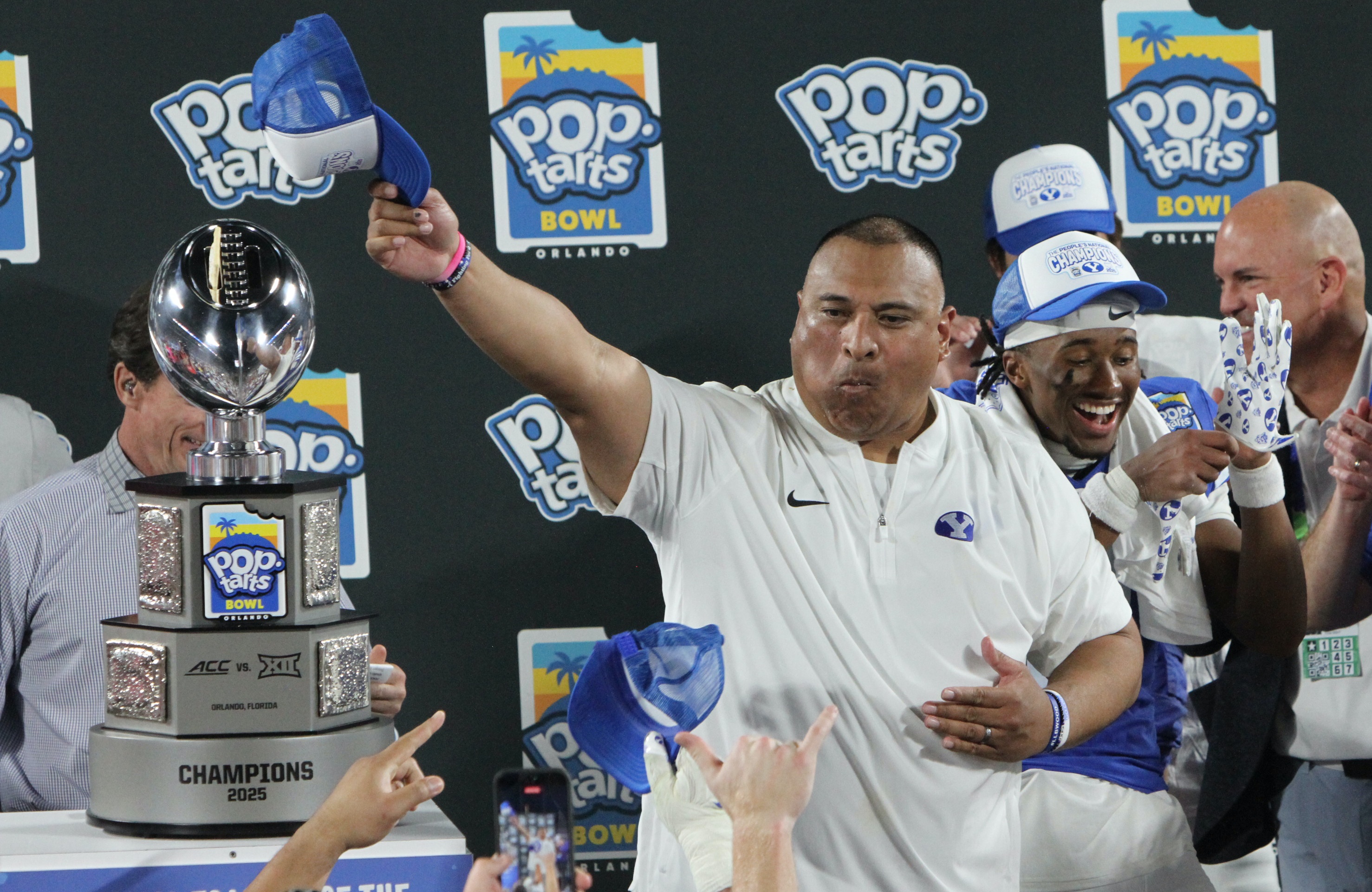 BYU coach Kalani Sitake celebrates with the Pop-Tarts Bowl trophy...
