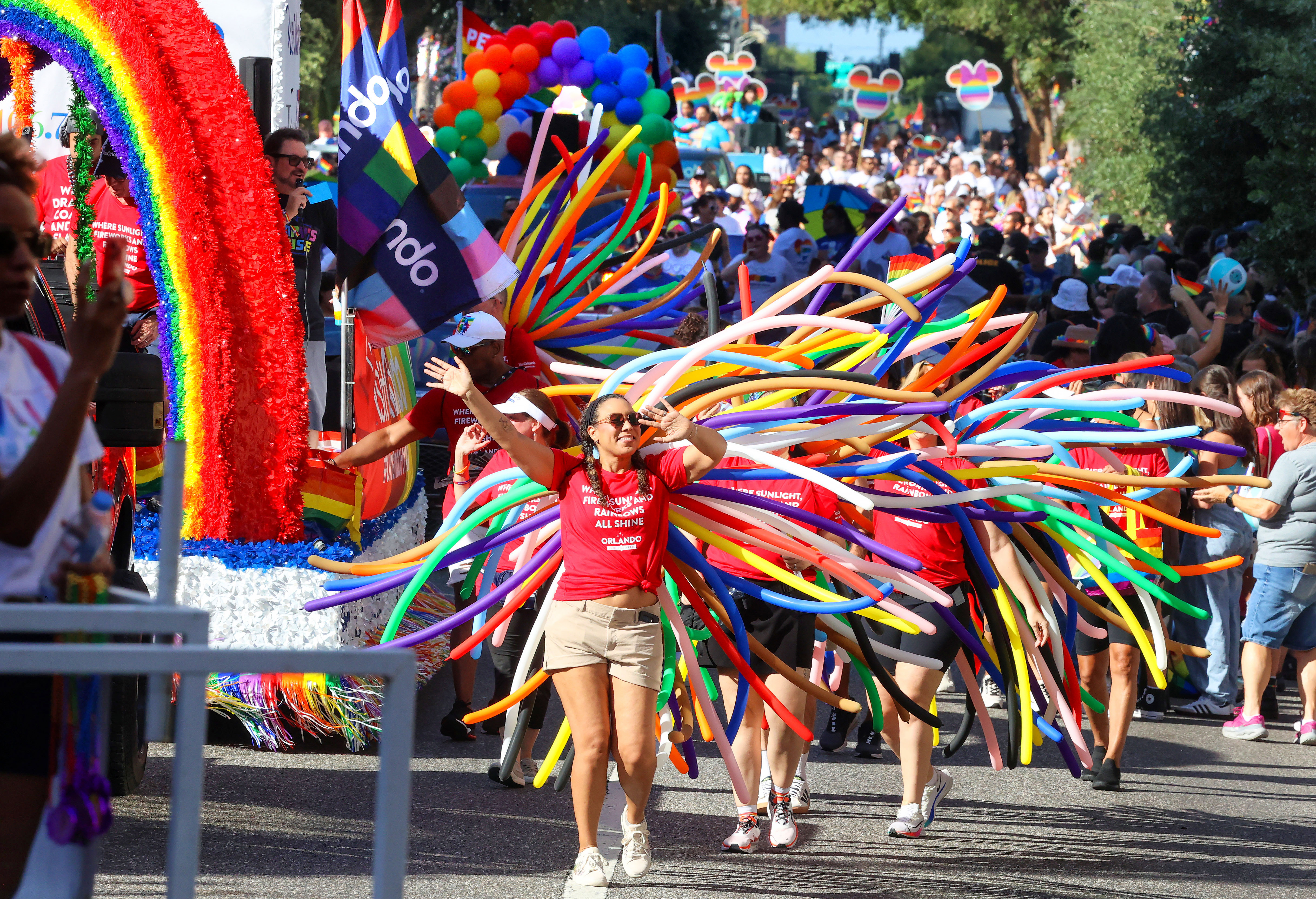 Dancers from Visit Orlando entertain with colorful balloons as the...