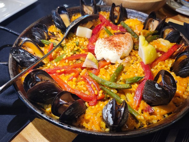 The paella at Spanish River Grill in New Smyrna Beach, loaded with shrimp, mussels, chicken, chorizo and calamari easily serves four. Do not let this deter you, even if you're dining alone. It's as dreamy pan-reheated with a fried egg on top as it in fresh from the kitchen. (Amy Drew Thompson/Orlando Sentinel)