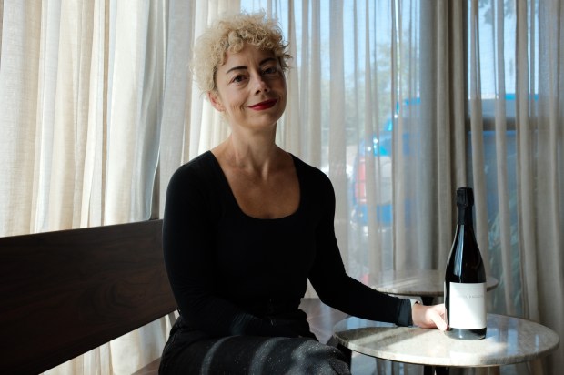 Heather LaVine, natural wine lover and owner of two wine shops/bars here in town, strikes a pose with a bottle l'Air du Paradis ($39), "the wine you can bring to any holiday party," she says. (Photo courtesy Quicksand Wine Bar)