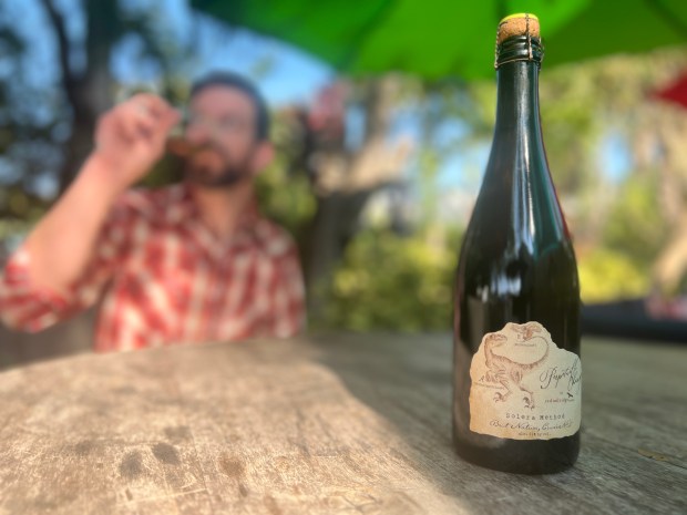 Rob Chase sips a favorite from Red Tail Ridge Winery at Digress Wine, his College Bar wine bar/shop. (Photo courtesy Digress Wine)