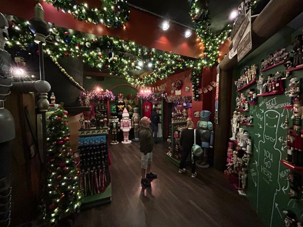 A Universal Studios visitor checks out the hundreds of nutcrackers featured inside the Tribute Holiday Market, a seasonal merchandise store at the theme park. (Dewayne Bevil/Orlando Sentinel)