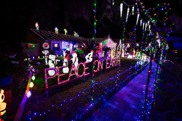 The light display at 3640 Oak Vista Lane in Winter Park promotes "Joy" and "Peace on Earth" complete with a jingle rock band on Dec. 10, 2025. (Patrick Connolly/Orlando Sentinel)