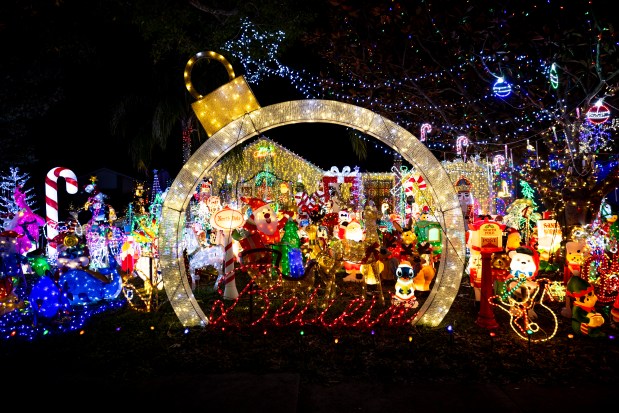 The bright holiday light spectacle at 11919 Allamanda Court in Orlando features snowmen, penguins, candy, toys, elves, Santa, and Disney characters on Dec. 15, 2025. (Patrick Connolly/Orlando Sentinel)