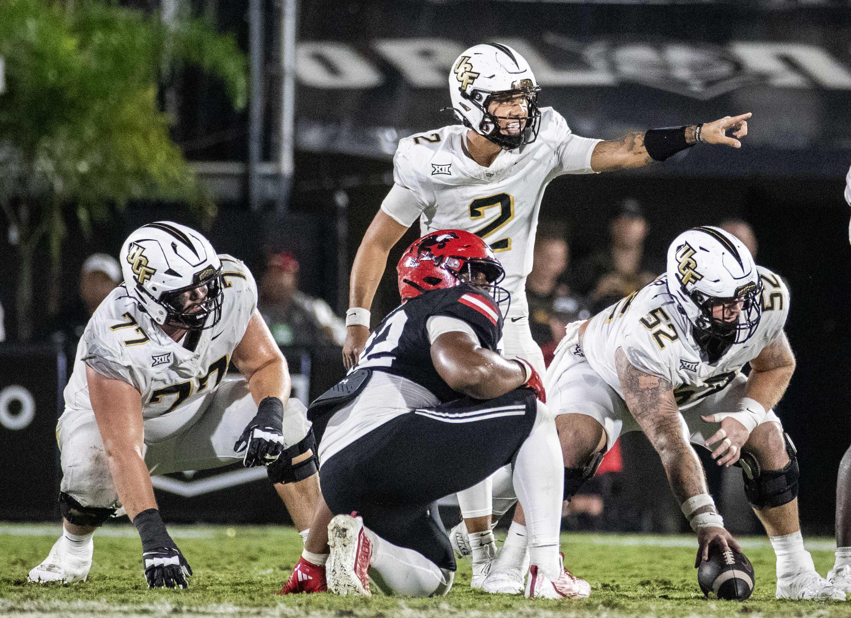 UCF Knights quarterback Tayven Jackson (2) makes an adjustment to...