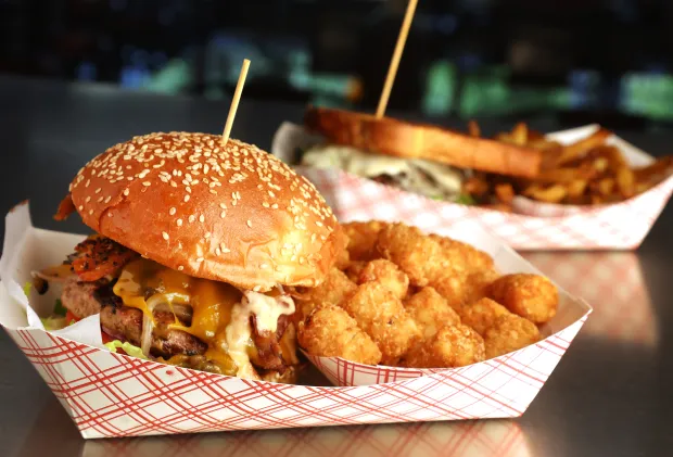 The Emperor burger and fries at Charm City Burger on Friday, August 25, 2023. After 15 years on Hillsboro Boulevard in Deerfield Beach, Charm City Burger Co. is moving into downtown Boca Raton. (Carline Jean/South Florida Sun Sentinel)