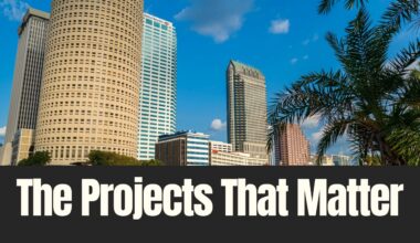 Downtown Tampa skyline with office towers and palm trees under a blue sky, illustrating major real estate projects shaping Tampa Bay.
