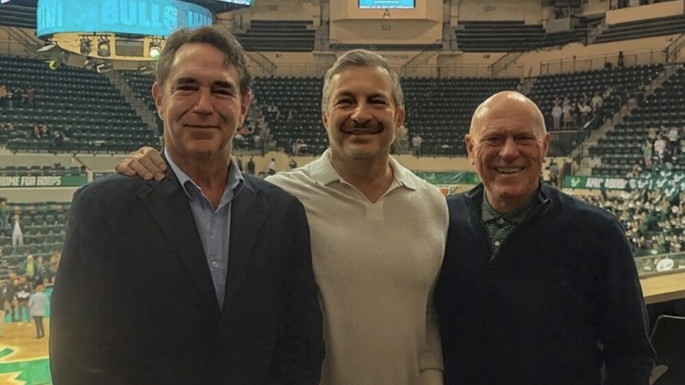 USF real estate program donor Jeffery Hills stands courtside at a University of South Florida basketball game