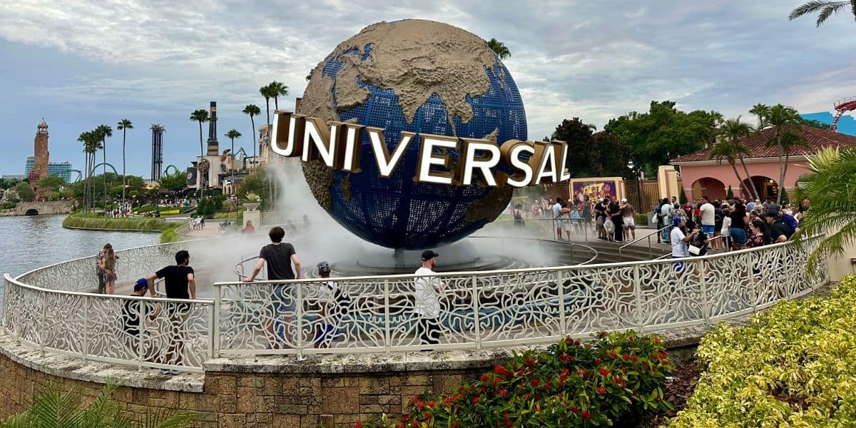 People gather around the iconic Universal Studios globe fountain