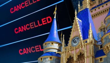 A digital board displays the word "CANCELLED" in red multiple times next to the spires of Cinderella Castle at a Disney World theme park at the airports cancel flights and shrink down access to the theme parks thanks to the government shutdown.