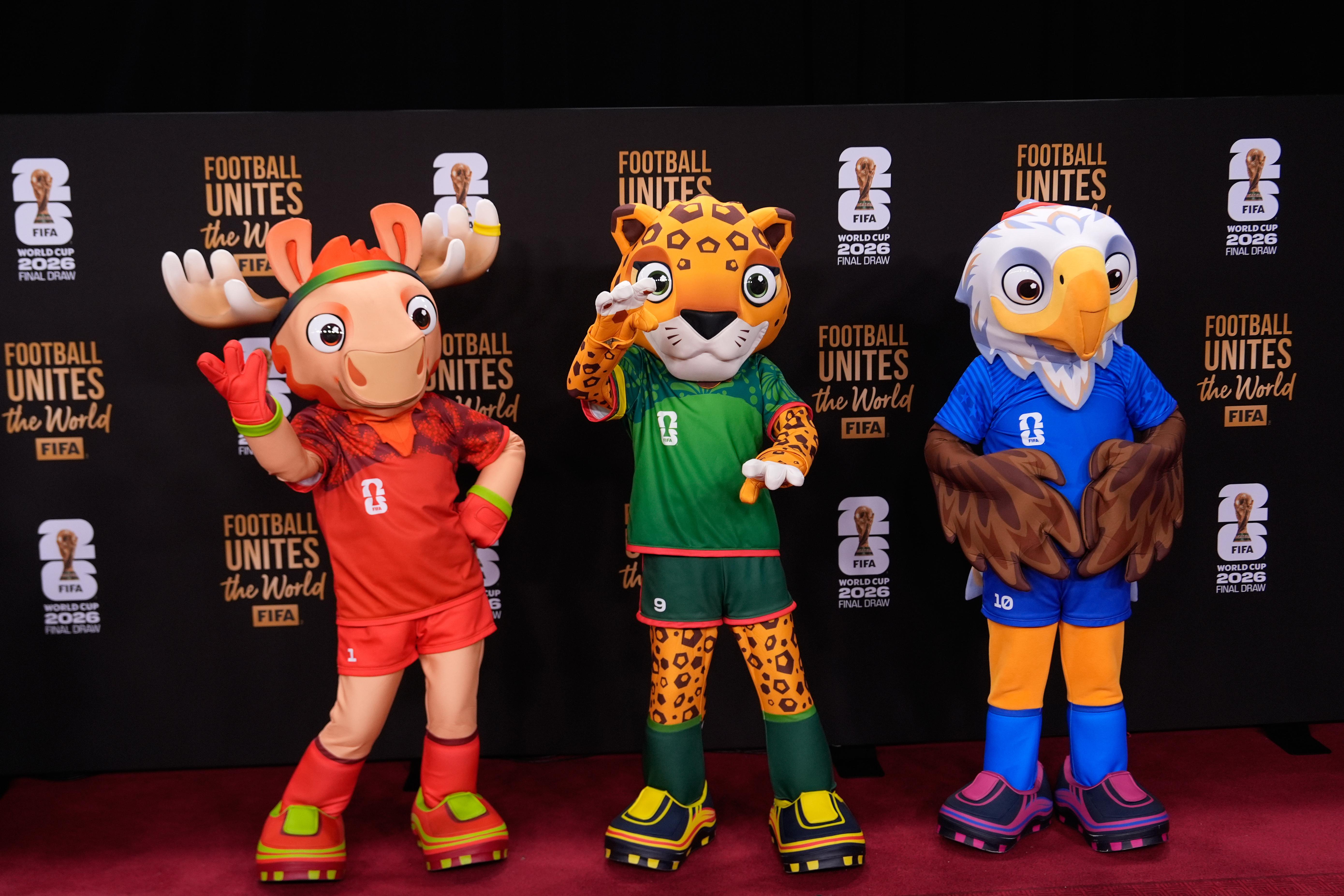 The tournament mascots pose on the red carpet as guests...