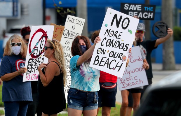 People opposed to a plan to build a private condo on public land at Hollywood beach protest outside City Hall on September 14, 2021.