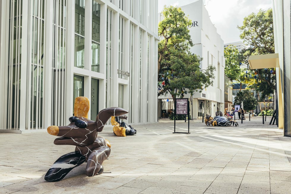Outdoor plaza featuring abstract sculptures and a retail environment Outdoor plaza featuring abstract sculptures and a retail environment